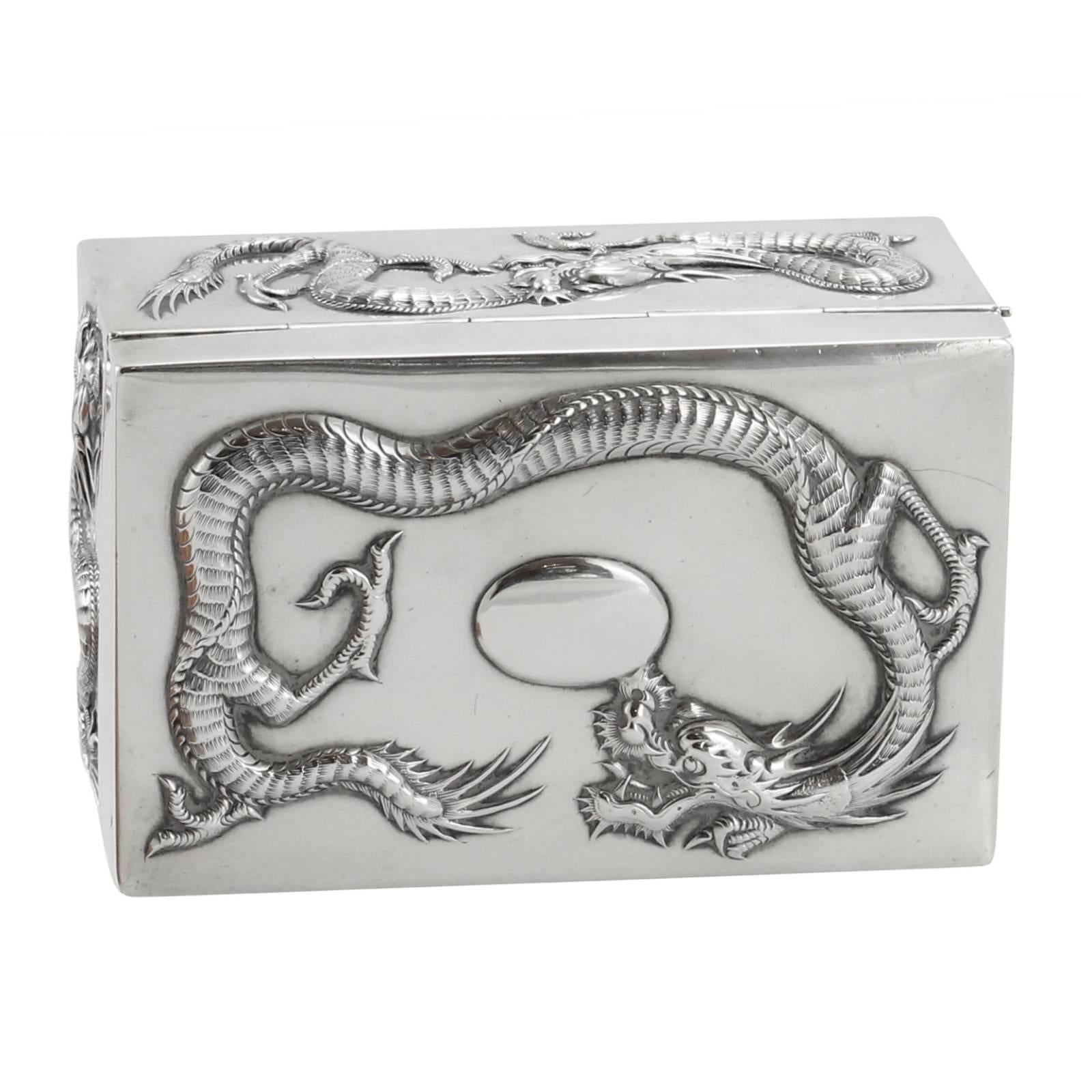A late 19th century Chinese Qing dynasty silver box, with the silver mark for Cumshing of Canton. The top, front, back and each side decorated with a three clawed dragon. Cumshing is often recognized as one of the longest operating retail