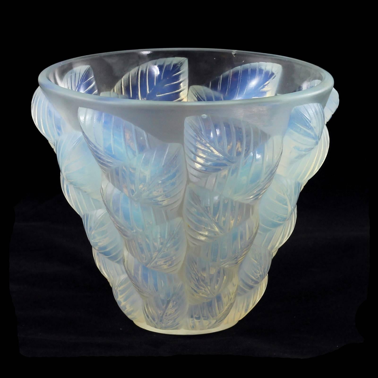 An early 20th century Art Deco glass vase in the 'Moissac' pattern by René Lalique. The opalescent glass displays varying hues of blue and green throughout the repeating leaf motif. The piece is signed "R. Lalique. France No 992."