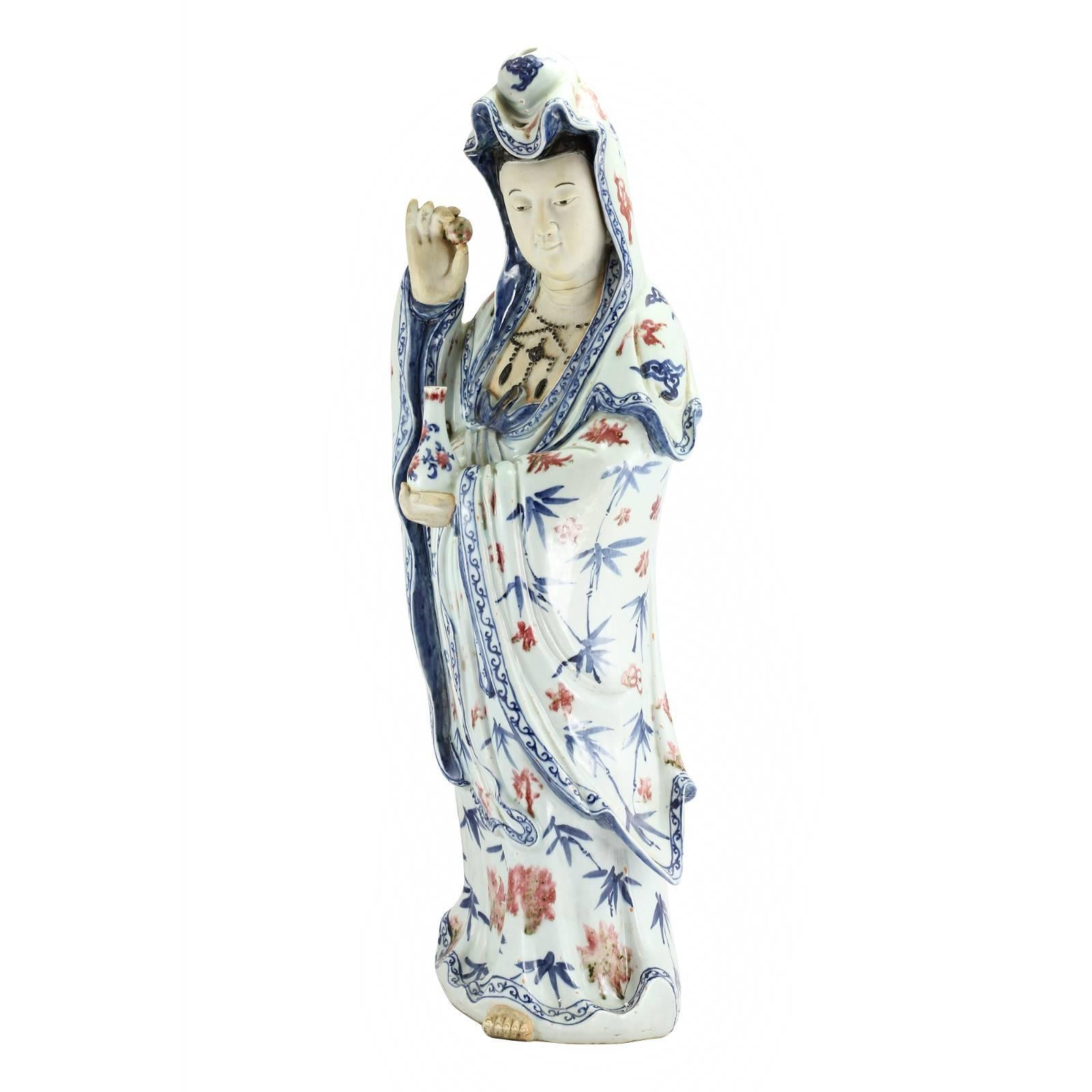 A large early 20th century Chinese porcelain figure of Guanyin. Guanyin is a bodhisattva associated with eastern Buddhism and Chinese Taoism. It is believed by some Buddhists that Guanyin places you in the heart of a lotus when you pass away, to be