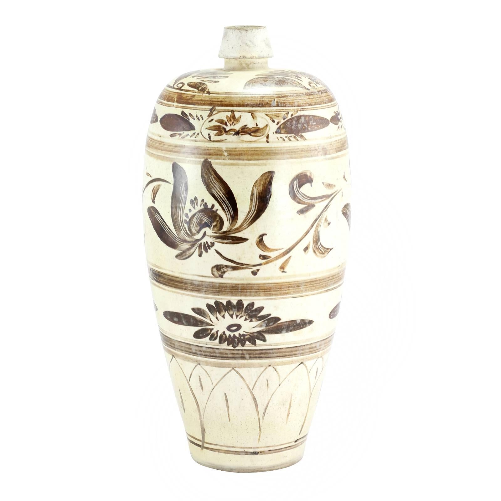 A Chinese Song dynasty Cizhou slip decorated meiping vase, decorated with a scrolling lotus pattern. Whilst Cizhou ware dates back to the late Tang dynasty, the style grew to become most popular and associated with Northern China during the Song and