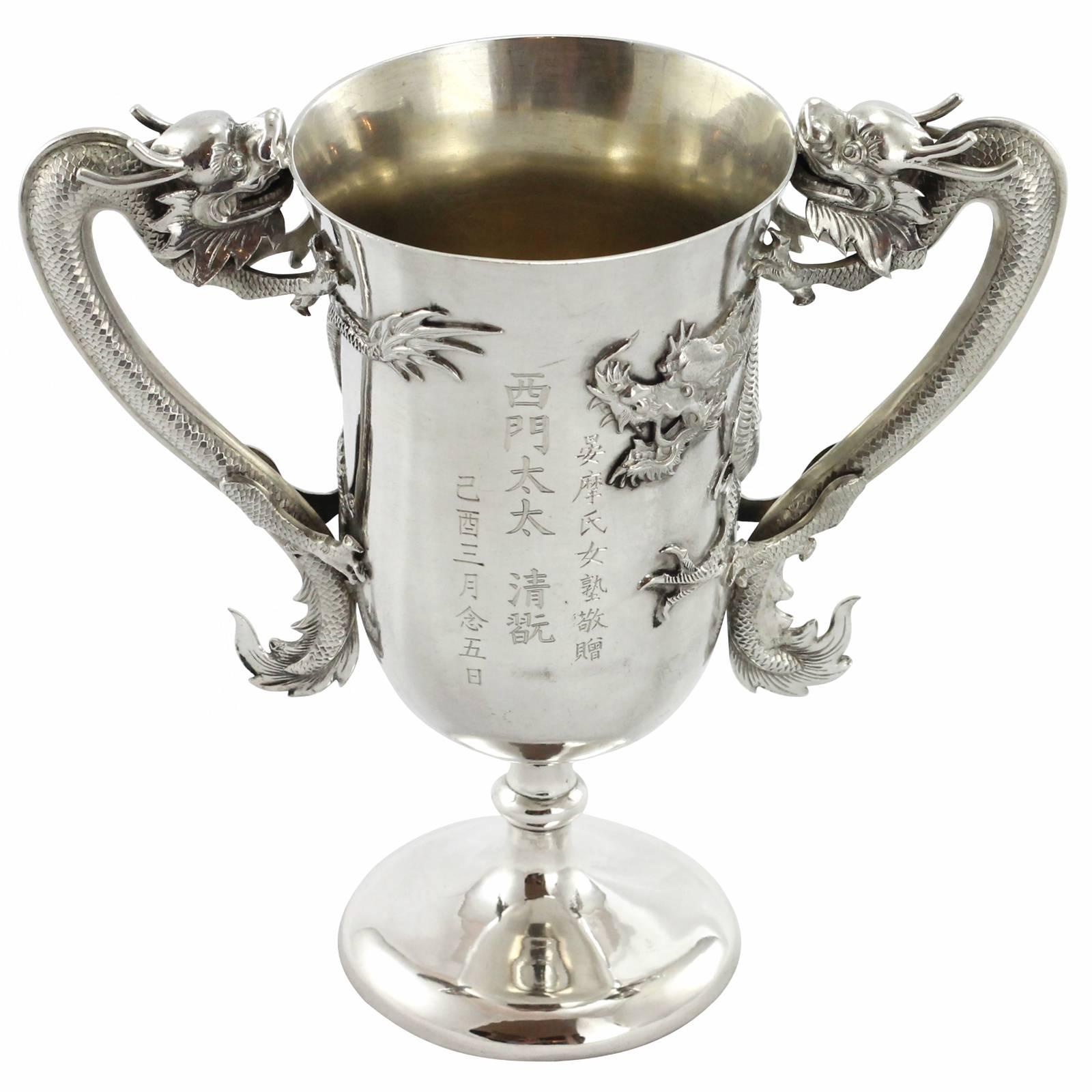An early 20th century Chinese export silver trophy by famed Shanghai silver retailers, Luen Wo. Known as one of China’s most prolific and desirable retail silversmiths, Luen Wo operated out of Shanghai from 1880 to 1940. This trophy features a pair
