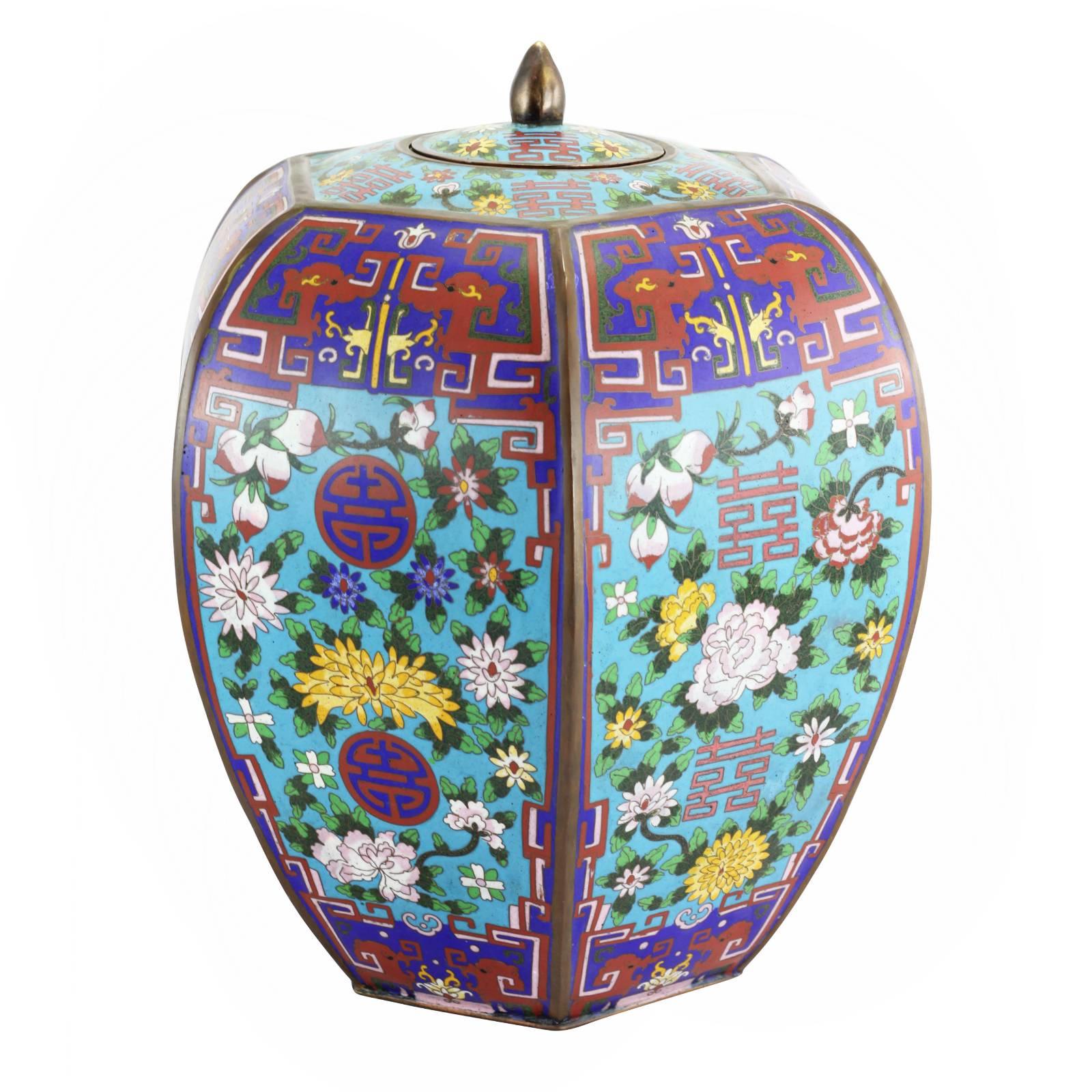 A pair of Chinese enamel lidded jars, dating to the mid-20th century, decorated with a cloisonne floral motif.

Cloisonne is an ancient technique used to decorate metalwork with inlays of enamel, which is exhibited in this colorful expression of