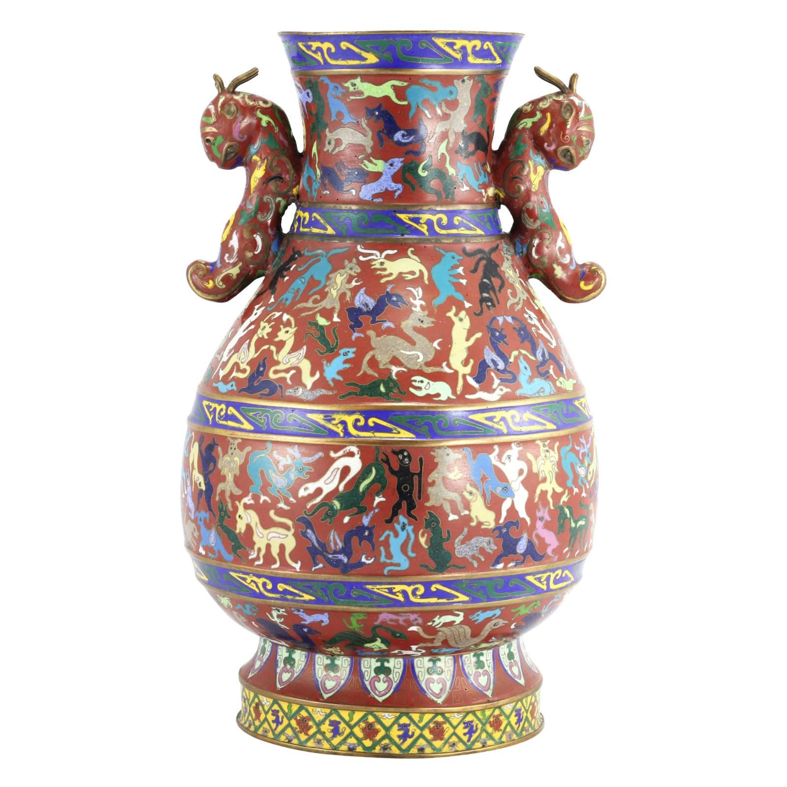 A pair of Chinese enamel vases, dating to the early 20th century, decorated with a cloisonne animal motif.

Cloisonne is an ancient technique used to decorate metalwork with inlays of enamel, which is exhibited in this colorful expression of