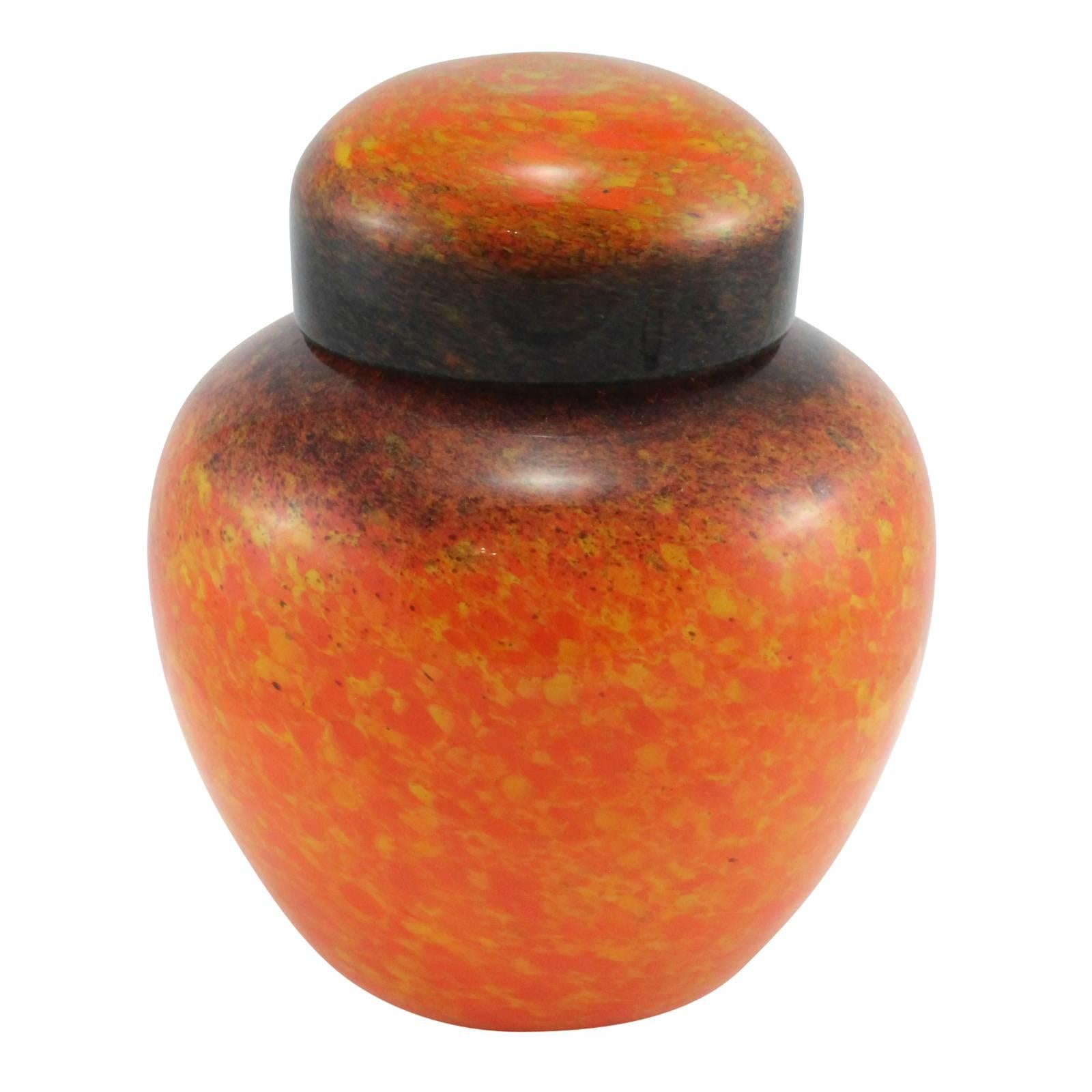 An early 20th century Art Deco orange, yellow, black and brown Monart glass ginger jar by John Moncrieff Ltd. Catalogued as Color 68, shape Z, size III.

