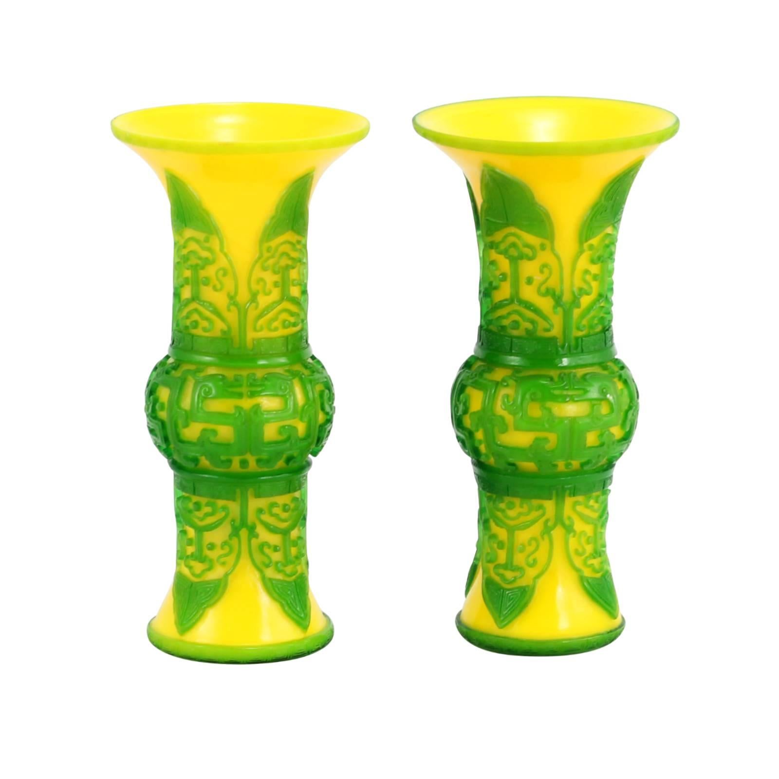 Early 20th century Chinese Peking glass 'gu' form vases. Yellow with green overlay.

Originating in Peking, China in the 18th century, this form of glasswork is achieved by layering different colored glasses around a core shape. The texture is