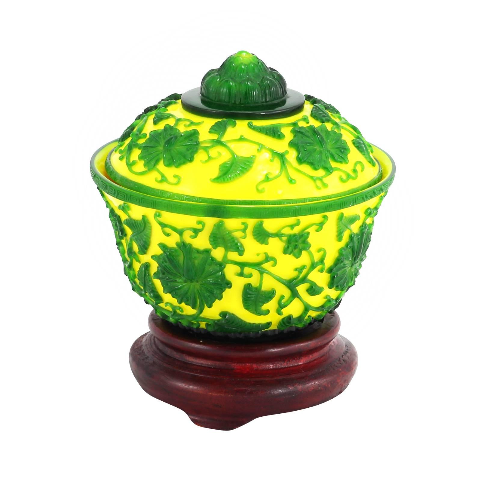 Late 19th century, Chinese yellow Peking glass lidded bowl with green overlay on wooden base.

Originating in Peking, China in the 18th century, this form of glasswork is achieved by layering different colored glasses around a core shape. The