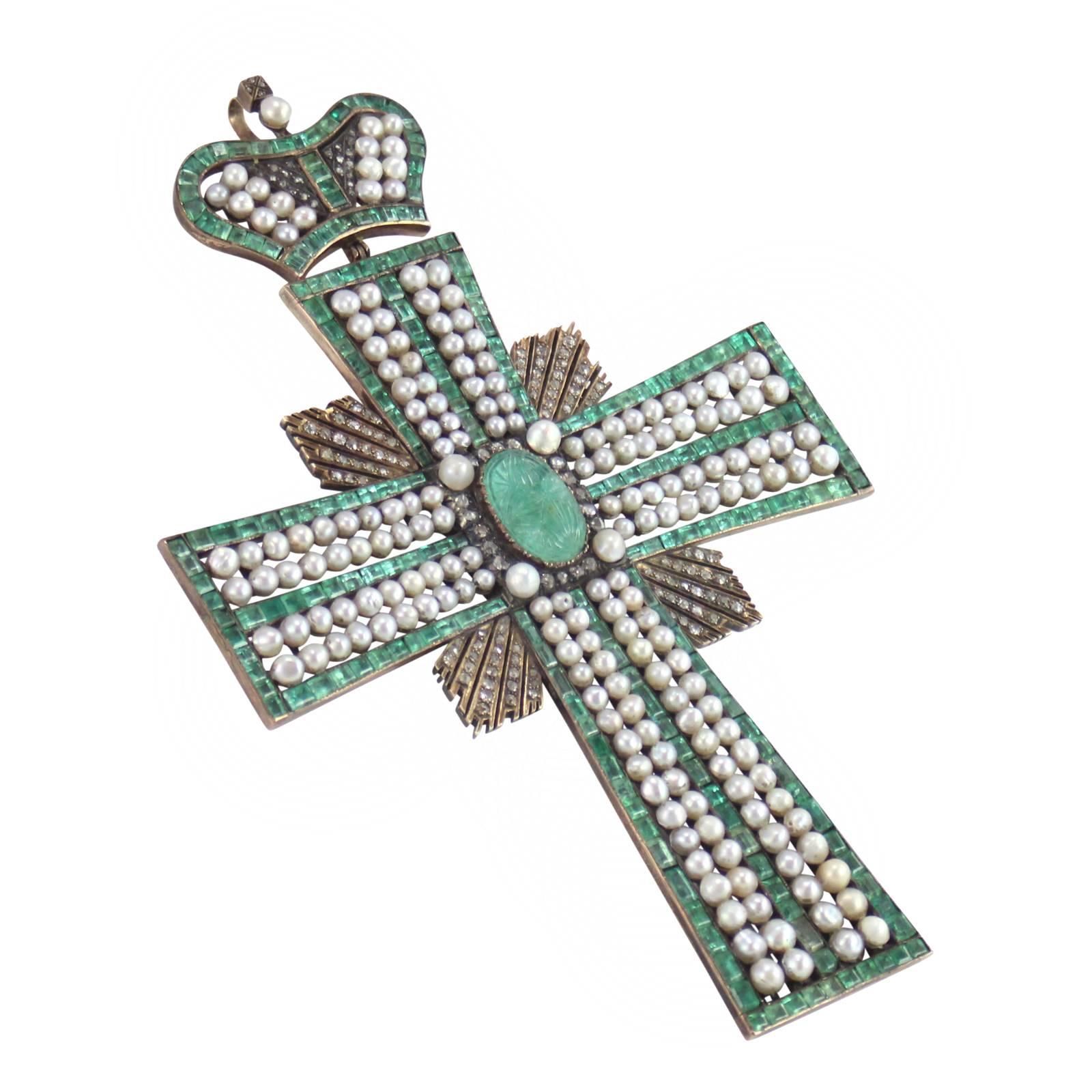 An emerald, pearl and diamond pectoral cross. This piece was presented by the Russian Imperial family to a high ranking member of the church for exemplary service to the crown. It features a carved barrel with the star of Bethlehem surrounded by