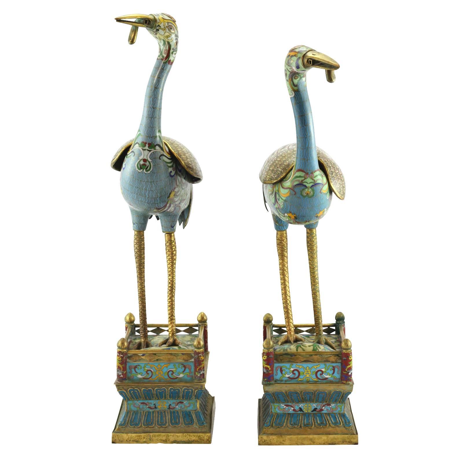 A pair of 20th century Chinese Republic figural cloisonné censers, in the form of cranes. Most likely manufactured as export ware between 1912 and 1949, this pair of incense burners feature detailed enamel work, with a variety of colors ranging from