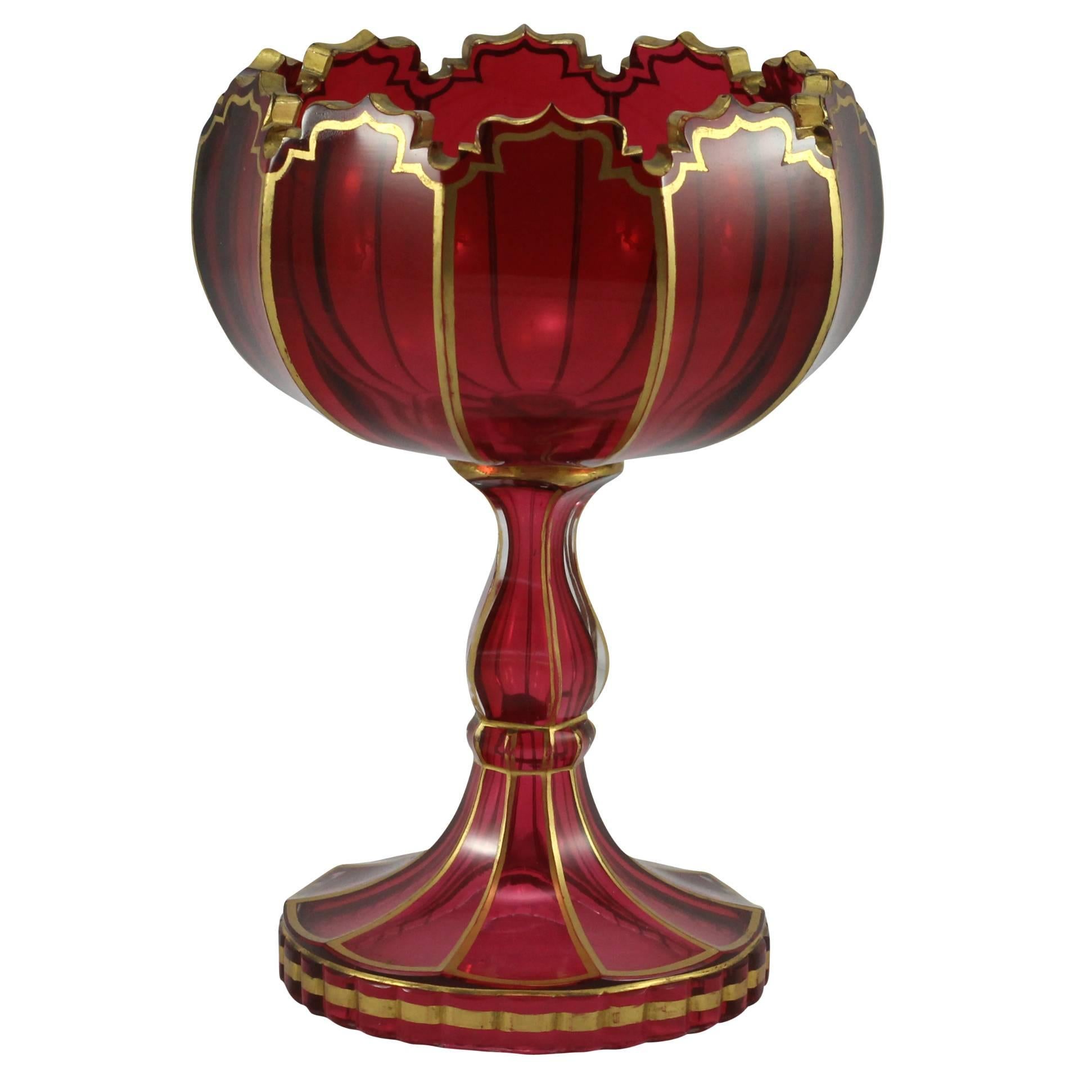 Richly blown in ruby glass, with gold gilt accents, this tazza leans heavily towards a Russian design influence.