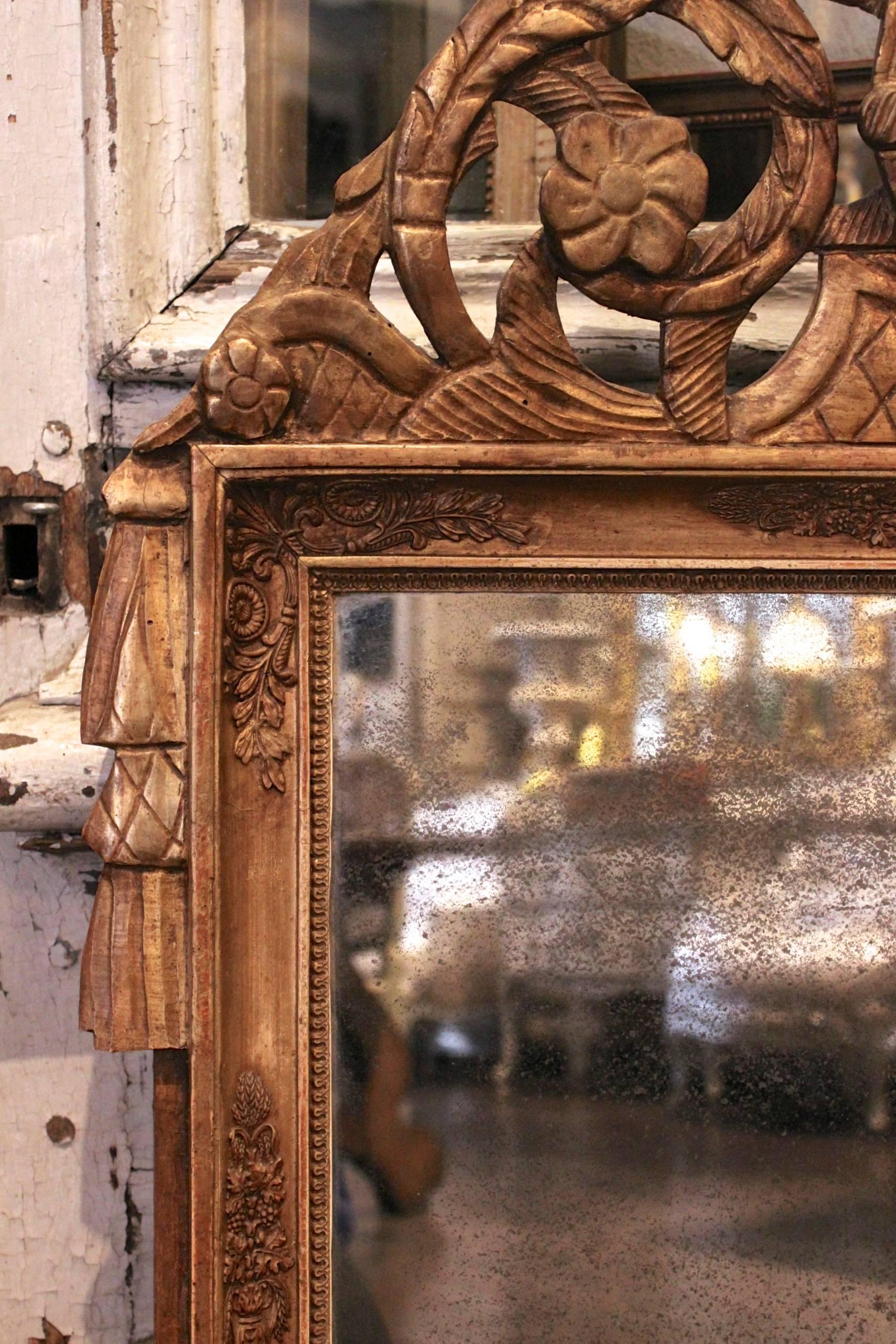 Antique French early 19th century. Period restoration I gilded mirror with detailed carvings throughout, cartouche with agrarian motif, and 1st generation mercury glass.

 
  