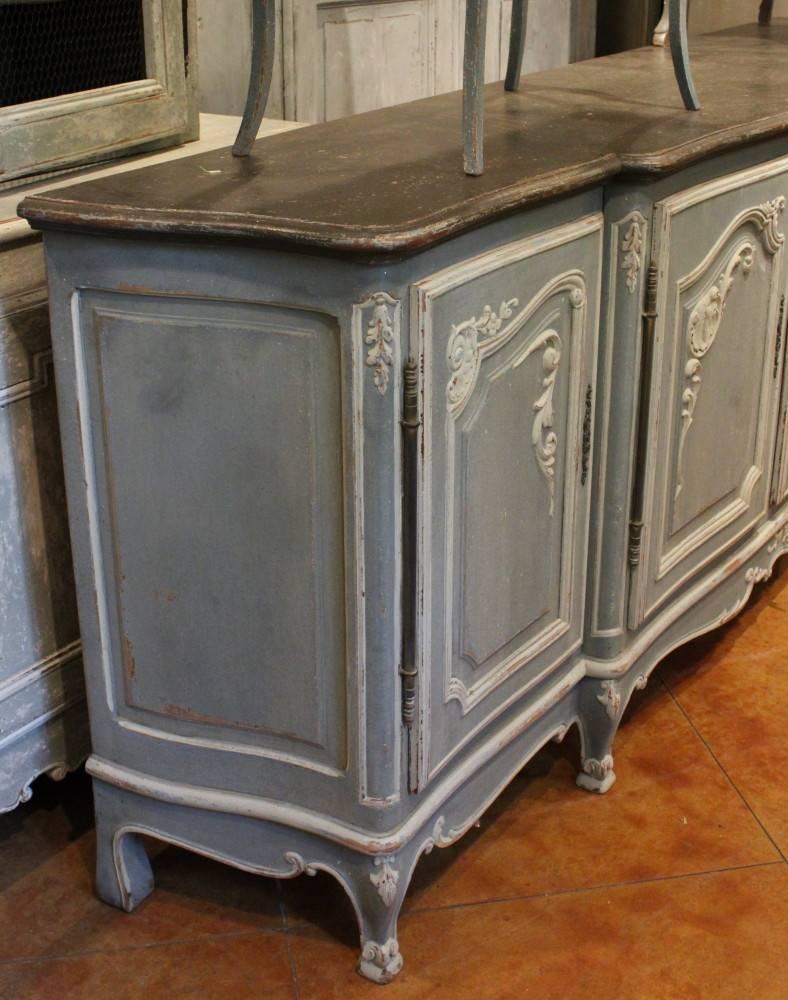 Extremely grand antique French Regence style enfilade from19th century with very detailed carvings on doors and base. Finished in pale blue French paint.