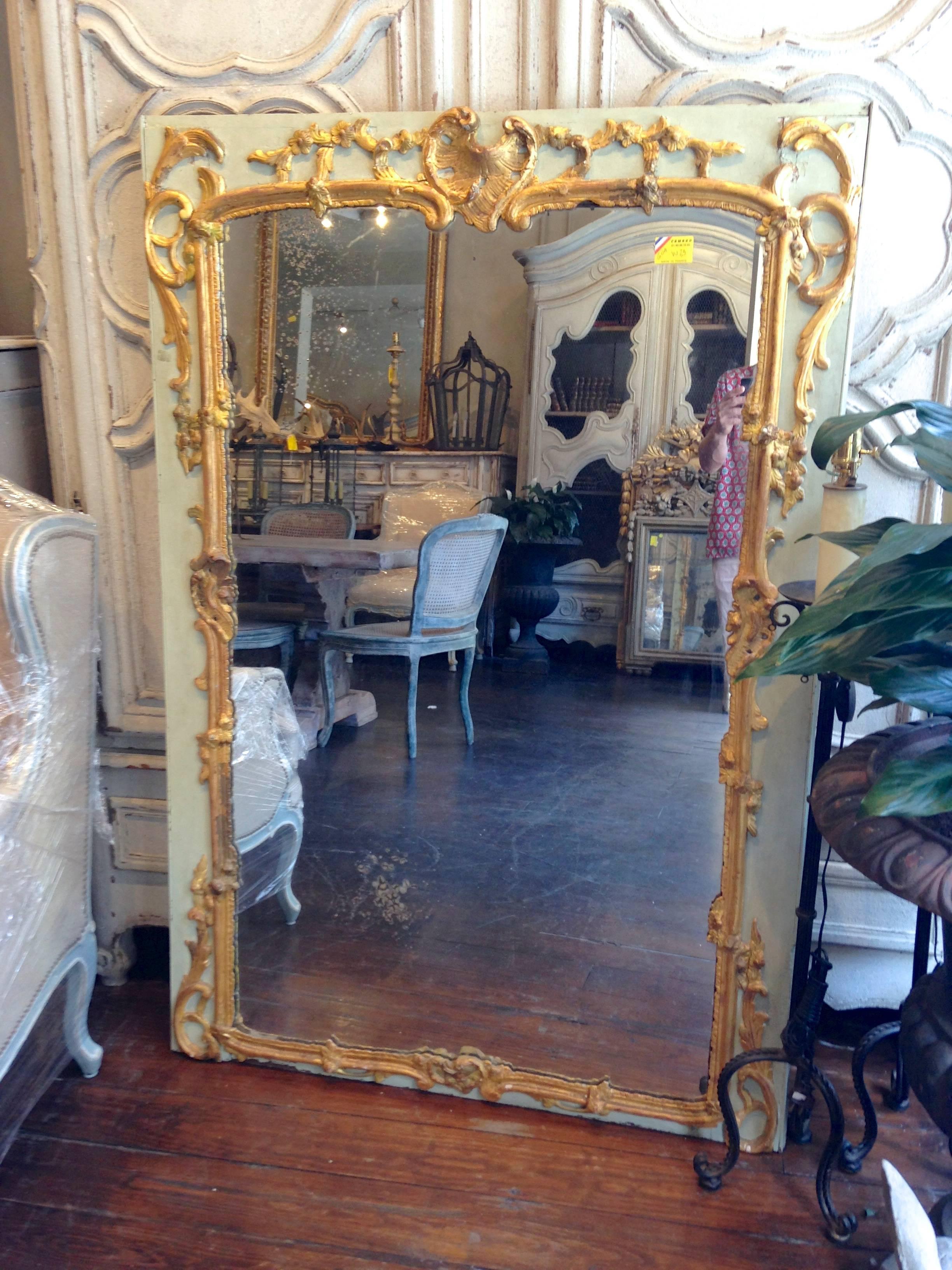 Antique French 18th century trumeau with extremely detailed gilded carvings, original mercury glass with signs of age, and French paint.
  