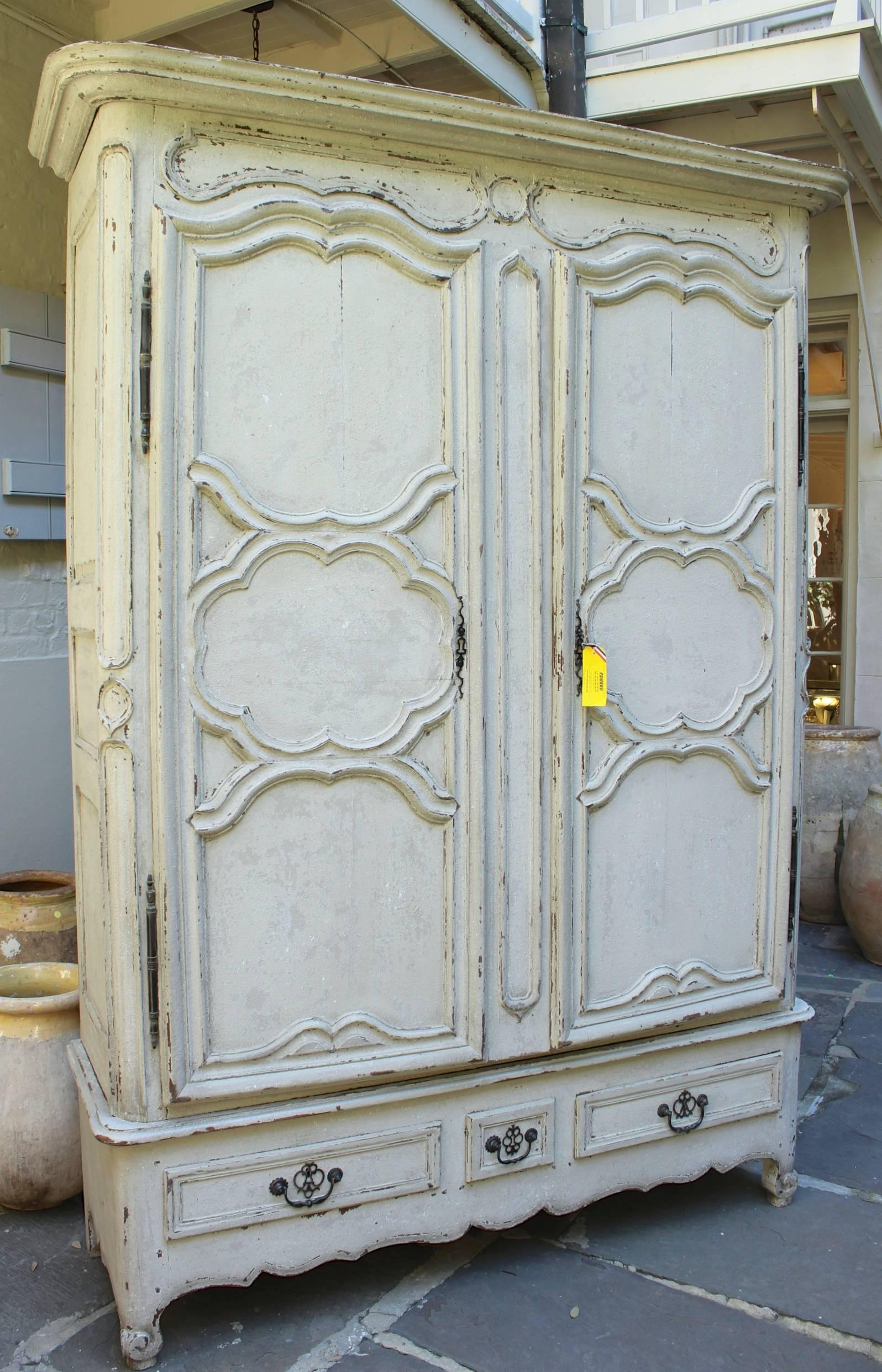 Antique French Regence style Armoire with hand-carved wood details.
End of 18th / Beginning of 19th century style with original pewter hinges and 3 drawer base.
  