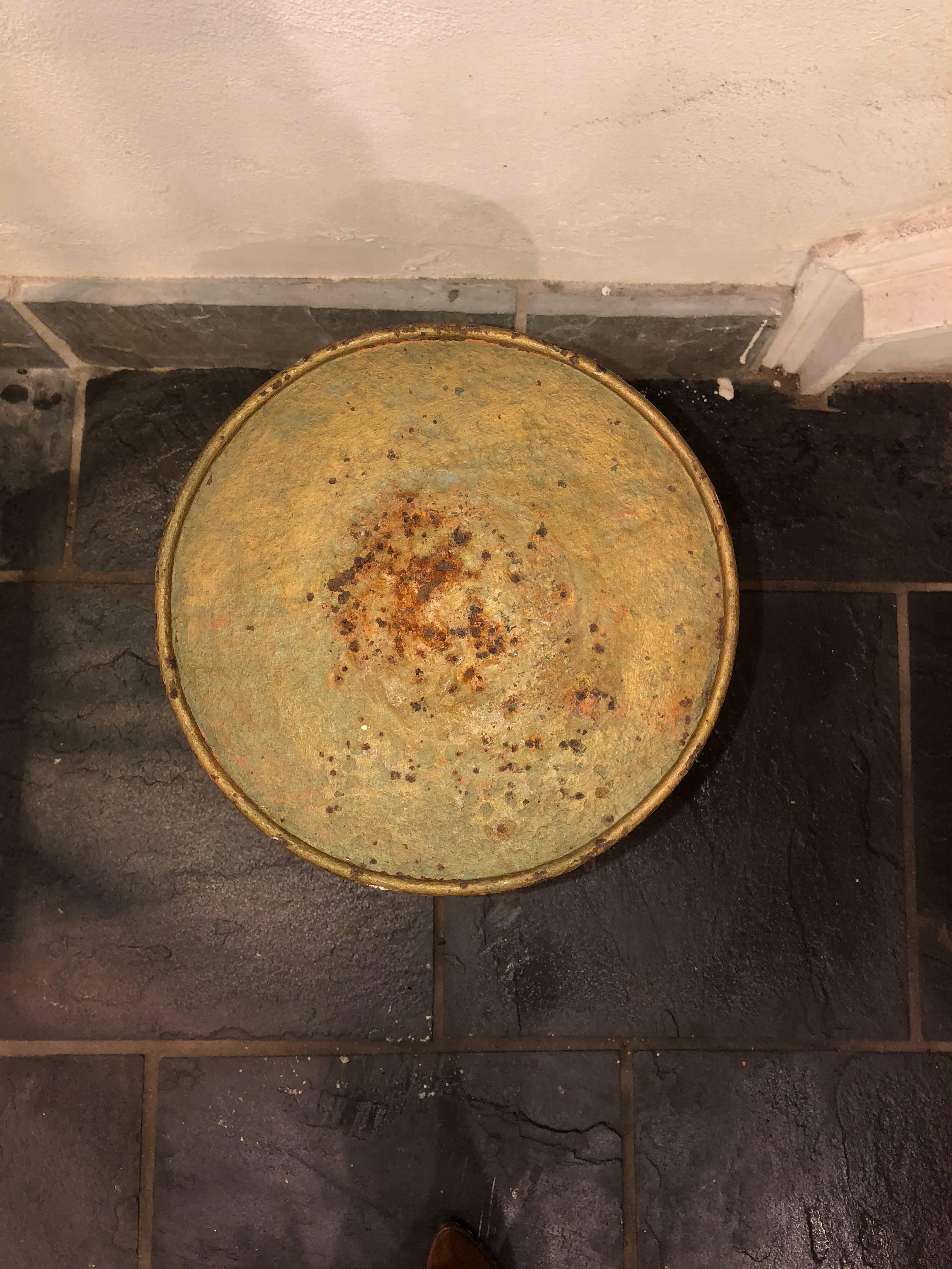 This vintage French martini table is a perfect piece to be nestled beside a canapé or bergère. This piece is made of iron and includes beautiful patina. 