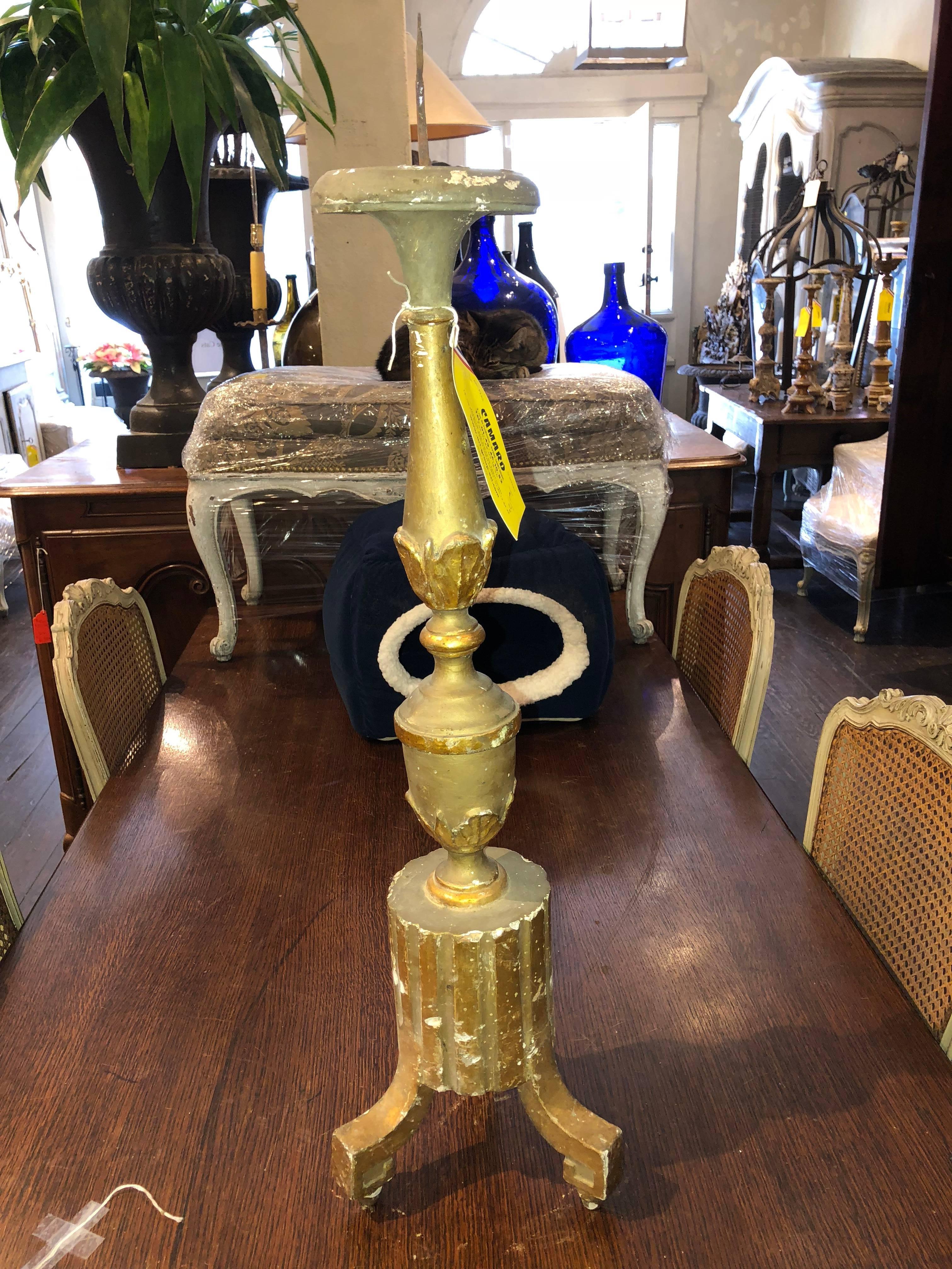 Complementary antique French altar candlesticks that can be converted to lamps. Includes detailed carvings and gilded areas. Price listed indicates price of each candlestick. Sold individually or as a pair.
