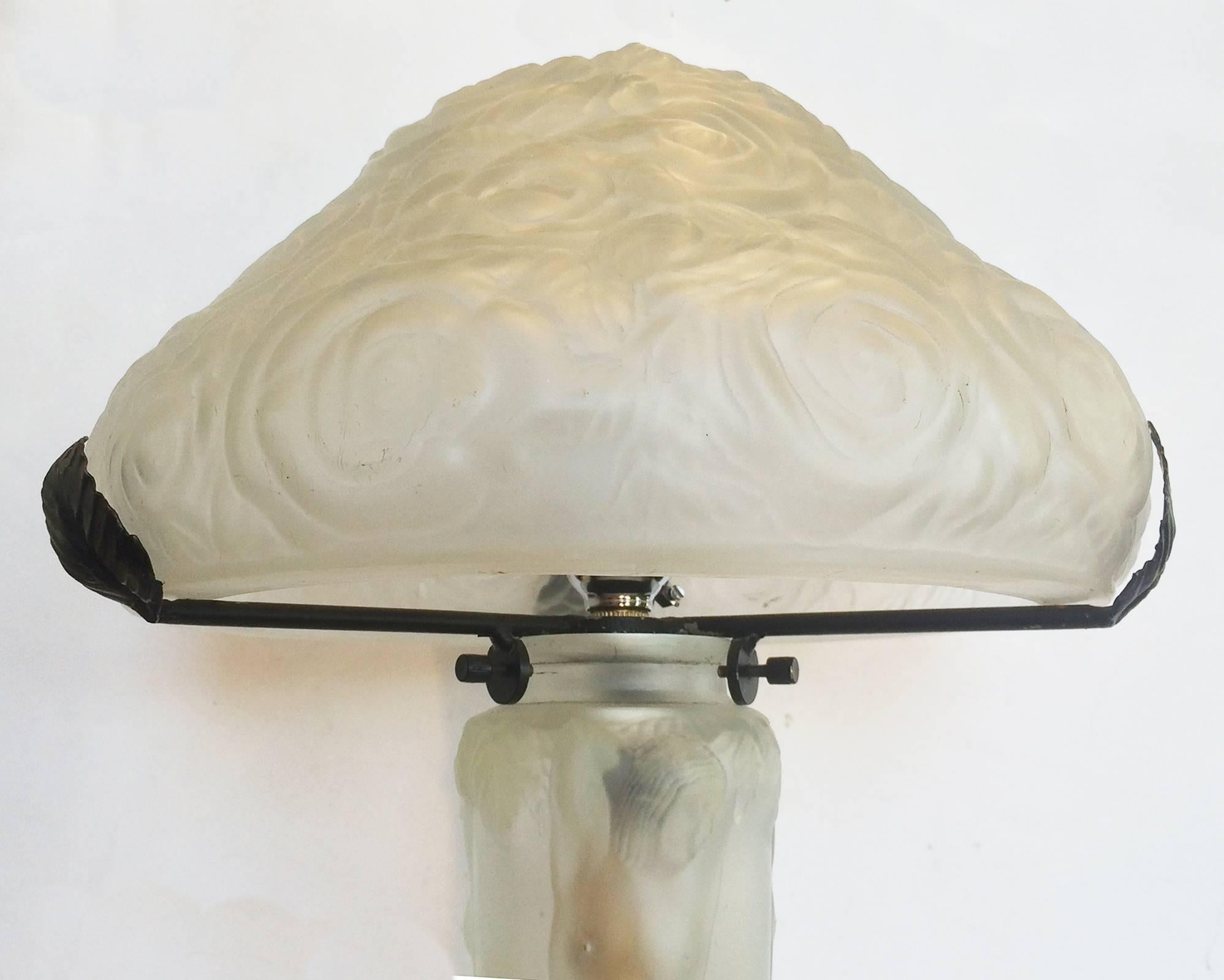 Art Deco lamp in satin clear glass, in design of roses and nudes. This lamp is of the rarer double light design, having a light in the upper shade and one also within the column support. The shade has Roses covering all the surface and is supported