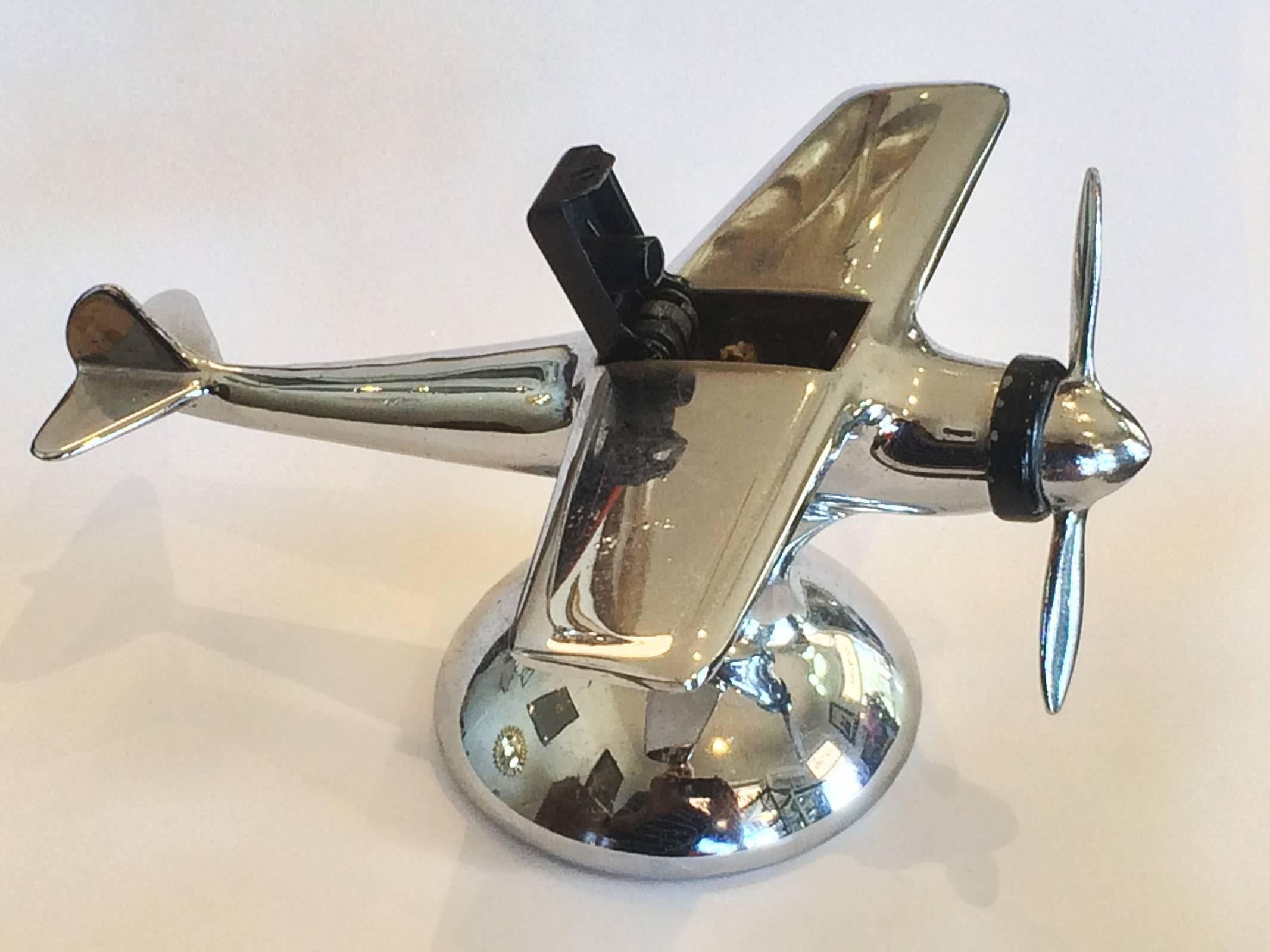 Art Deco cigarette lighter, 1930 Aeroplane by Hamilton's U.S.A.. Fantastic condition for age, with flint and fuel inlet at bottom of stand. Spin the propeller to “jettison” the cockpit cover, exposing the wick and flame from within the cockpit.