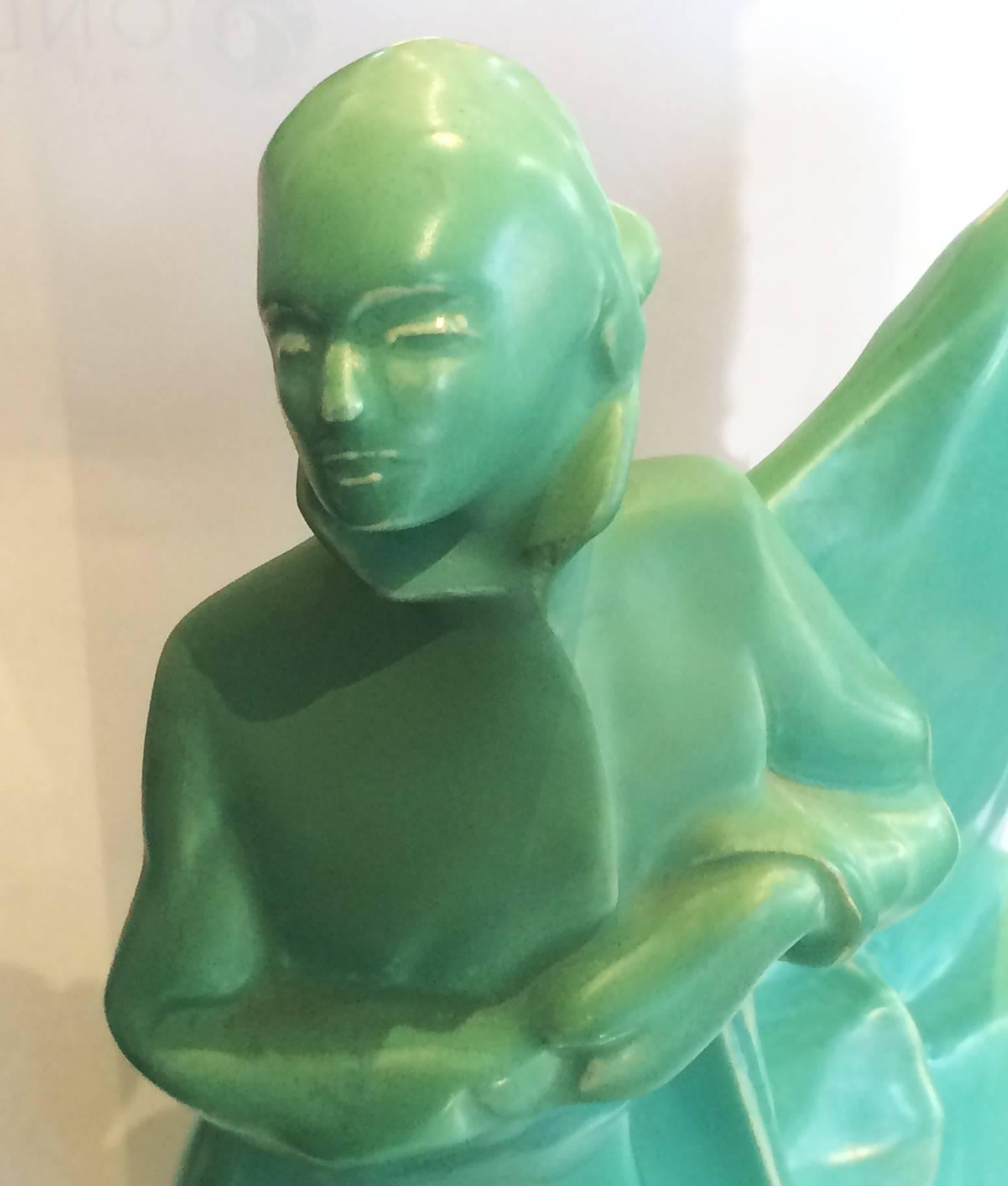 Art Deco statue of lady skier, with skis and poles, in front of a snowdrift, all in green craquele paste finish. All in perfect condition with no chips, cracks or repairs. Impressed marked to base “MADE IN BELGIUM” followed by “#660,” circa 1930,