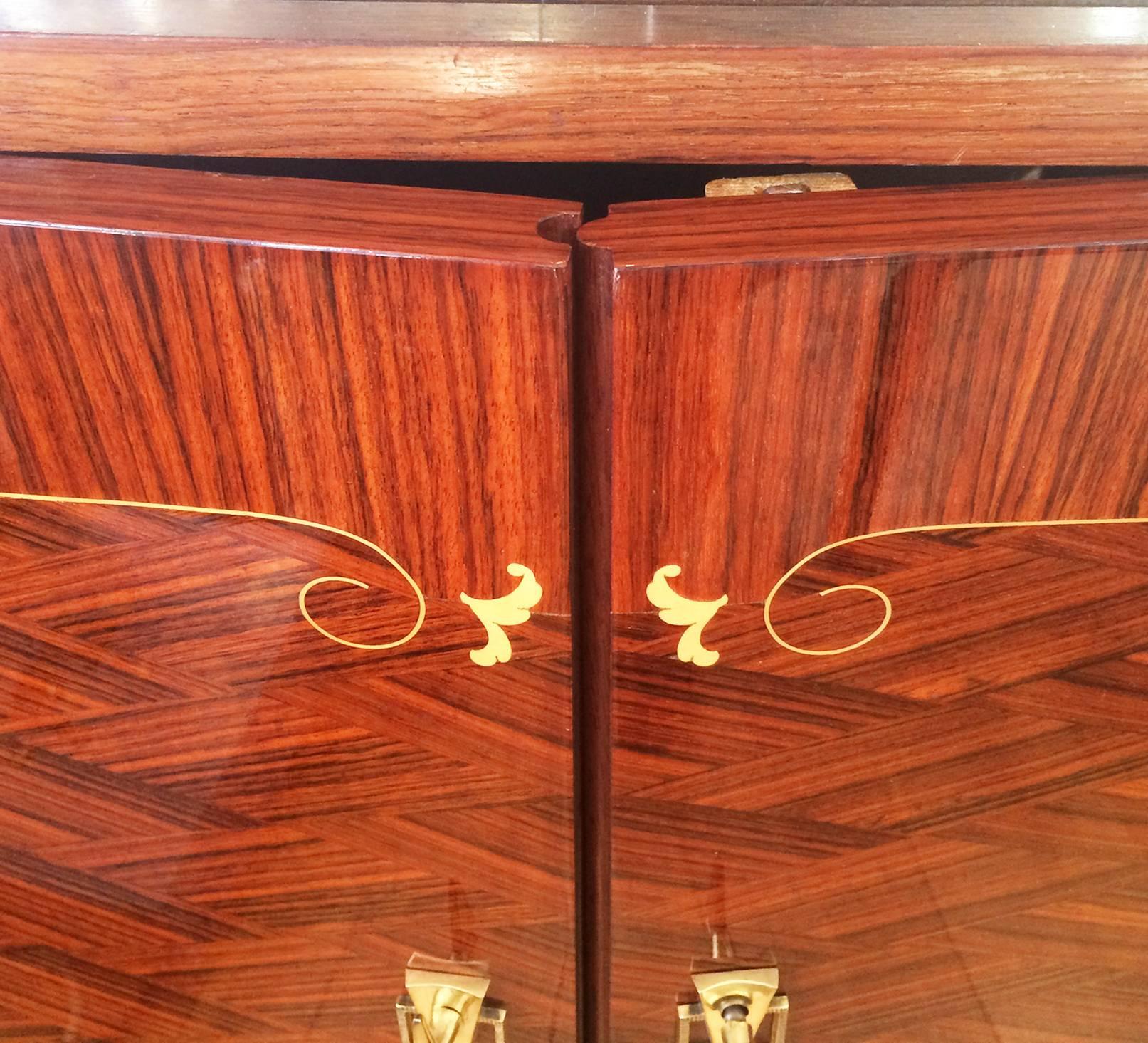 Art Deco finely inlaid French cabinet, for bar or display, inlaid with birch, and having interlocking door, security, triple lock point mechanism, double throw French lock, and adjustable leg heights. Extremely fine craftsmanship to the inlay, and