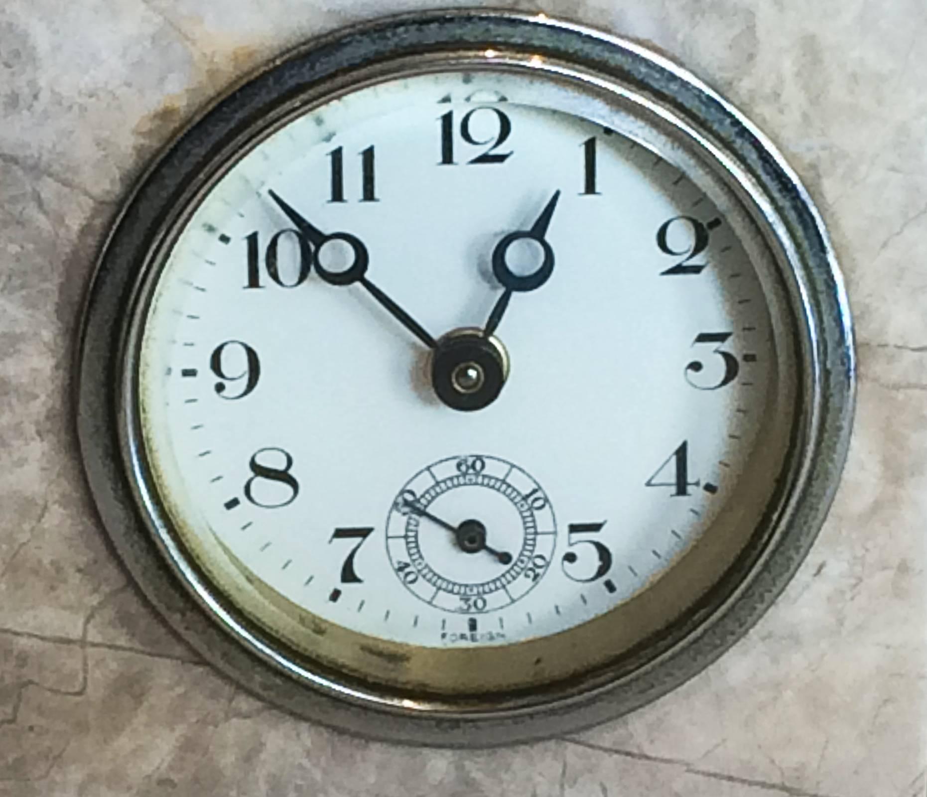 Ultra, Art Deco clock in geometric black and white marble design with white enamel face, arabic numerals in black and also minute dial. Marked “FOREIGN” to both lower front and rear dial areas. Probably German workings and post 1915 for English