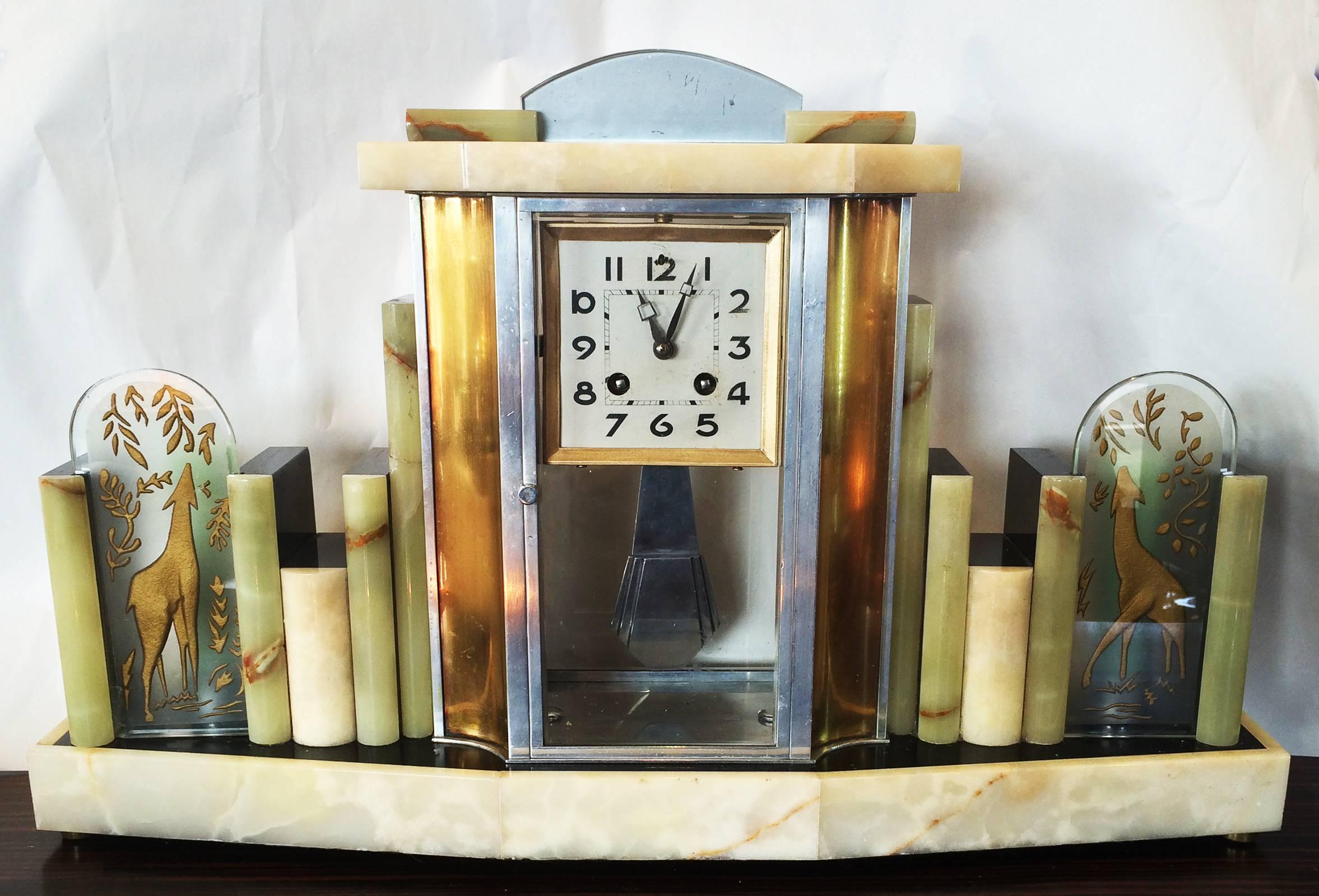 Clock of marble and alabaster, and very rare, having a low power, nightlight either side of the clock, with shades of engraved and gilt deer, eating tree foliage. An outstanding piece of design and Craftsmanship with many features, including