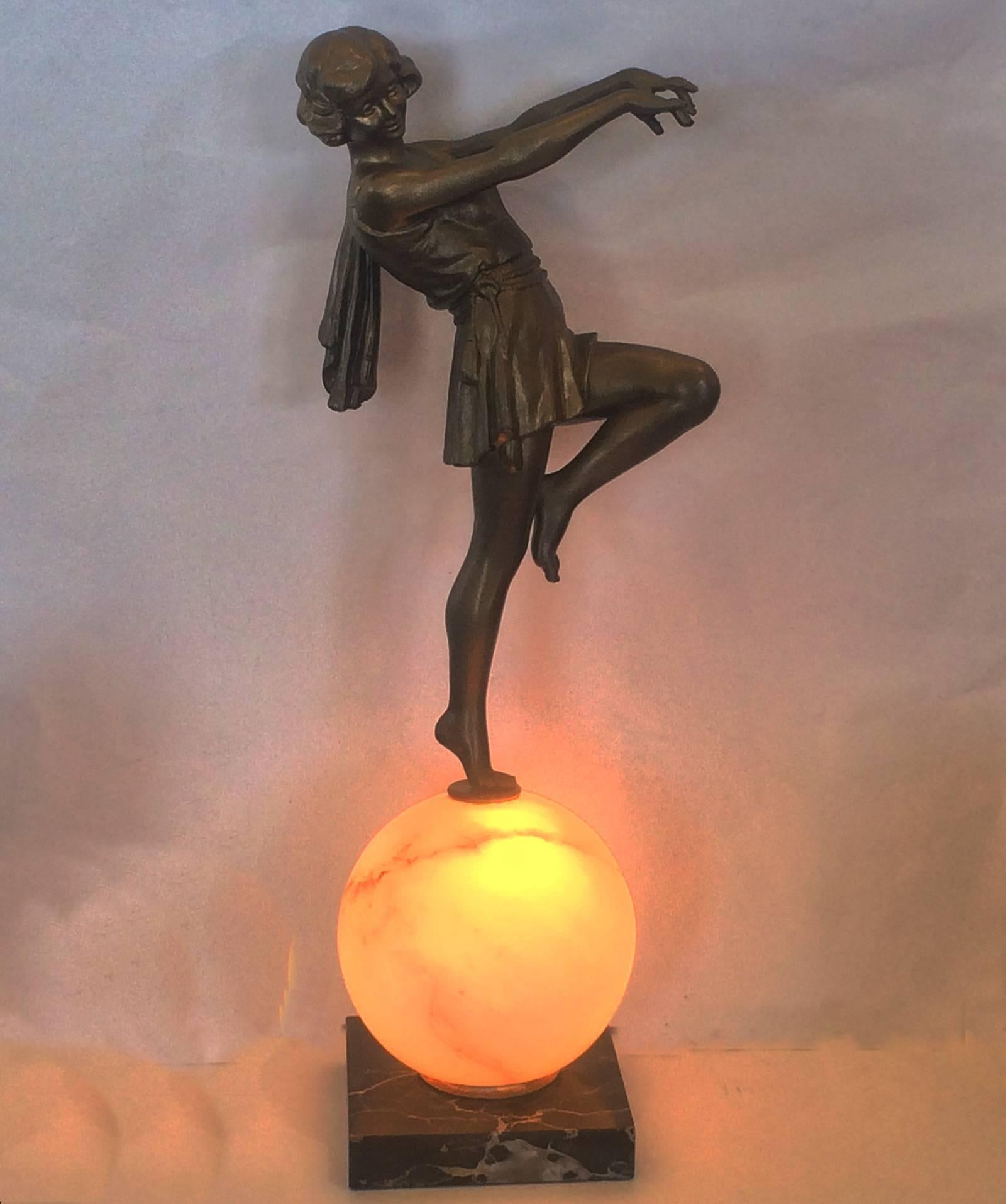 Rare Art Deco lamp with dancer on illuminated alabaster sphere. Amazing design, finely detailed and in exceptional condition. White Alabaster finely veined with black and grey, and Italian Portorro Mable, black with white and “gold” veins. Re-wired