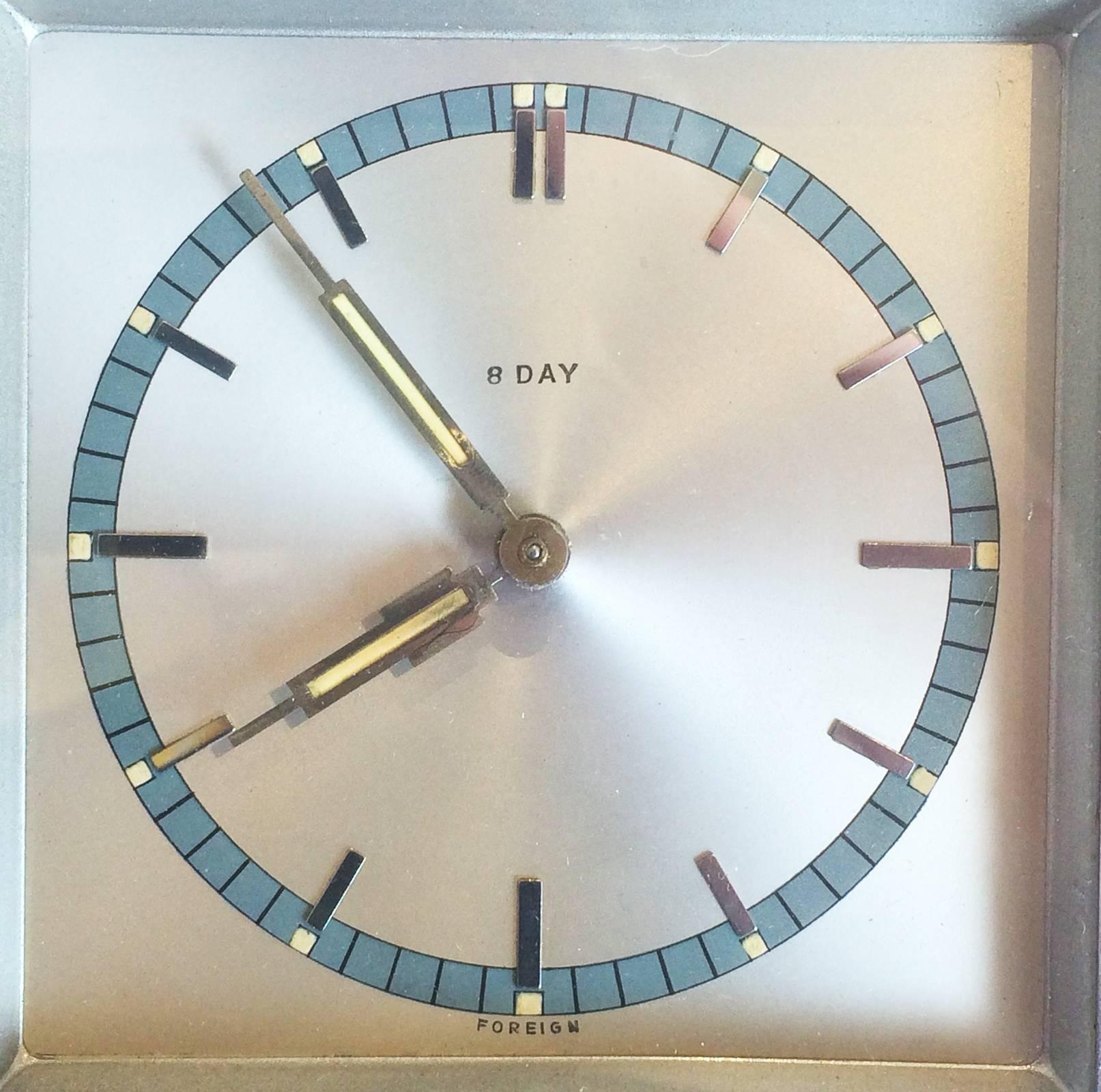 Art Deco French clock with bright chrome outer and satin chrome face, sky blue rim with chrome batons for 5 minute increments, double baton for Noon, and aluminous hands and small illuminous squares at each baton. Clock face is immaculate, with some