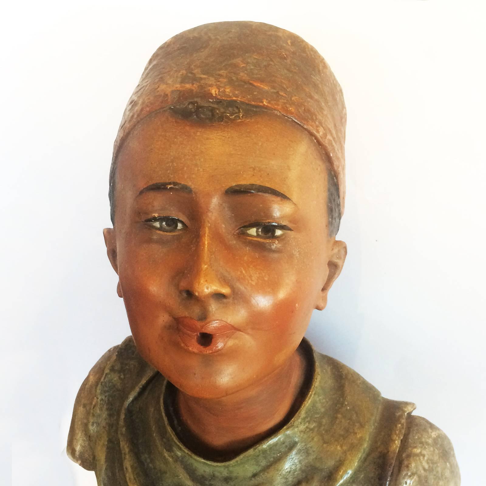 Art Deco bust in painted terracotta, advertising Turkish cigarettes. Finely detailed and in polychrome colours, with traditional Fez (hat) with black tassel falling to the rear, all on a black,
turned socle at base. The face is amazingly life-like,