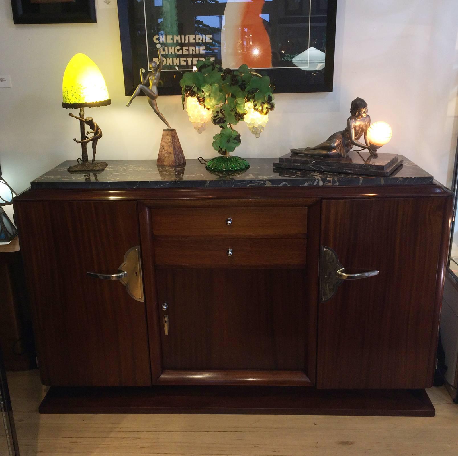 Art Deco sideboard in amboyna wood, stepped, curved top edges and a stepped base. The top has a magnificent piece of Portoro Italian marble. There is an amazing amount of detail in the sideboard, having a full height cupboard at each end, an in the