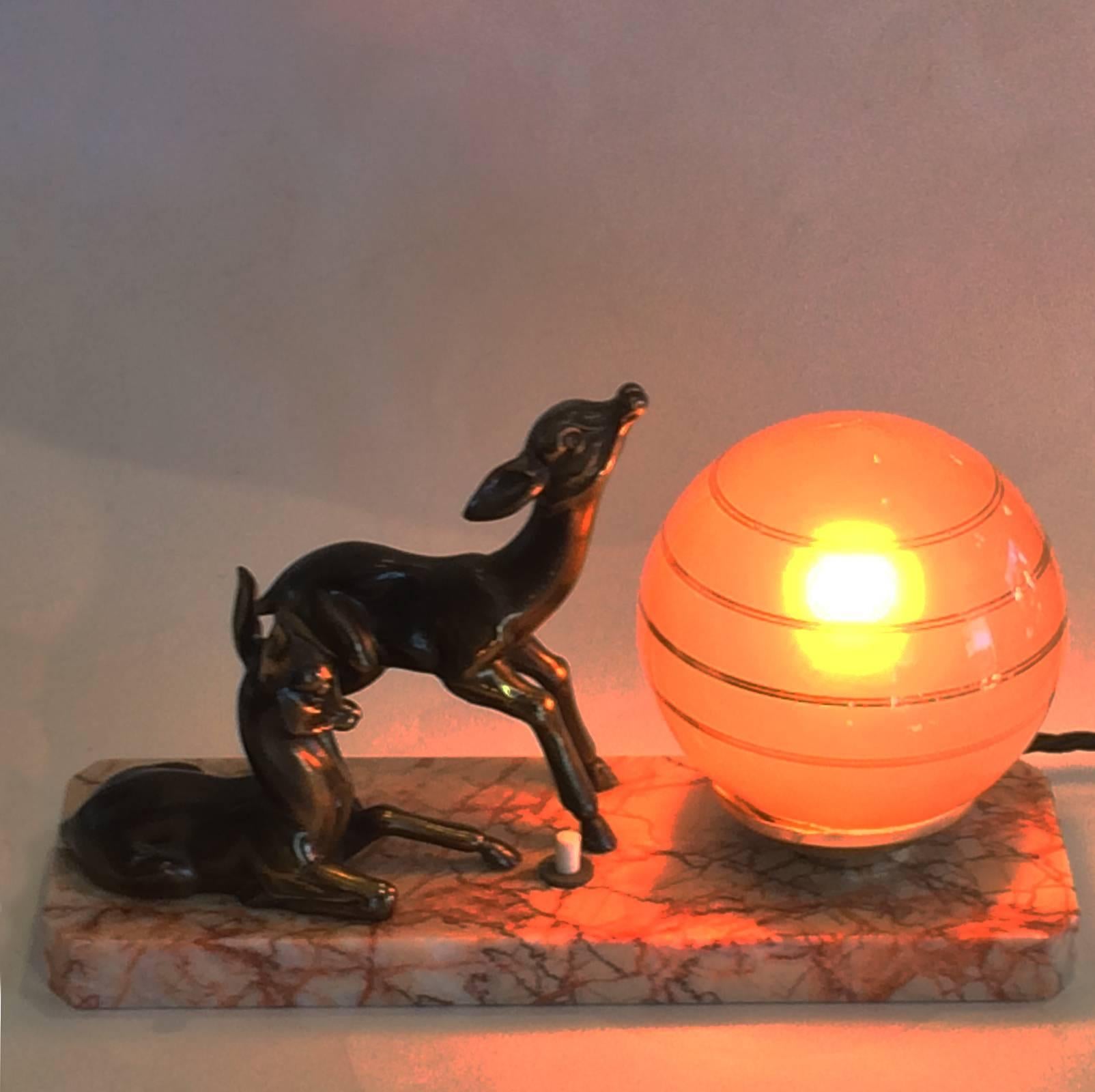Art Deco French night light, featuring two deer fawns, Font De Art, bronze on white metal statues with Japanned finish (black enamel highlights to bronze). Still retaining original small, light pink glass shade, satin interior, with perfect outer