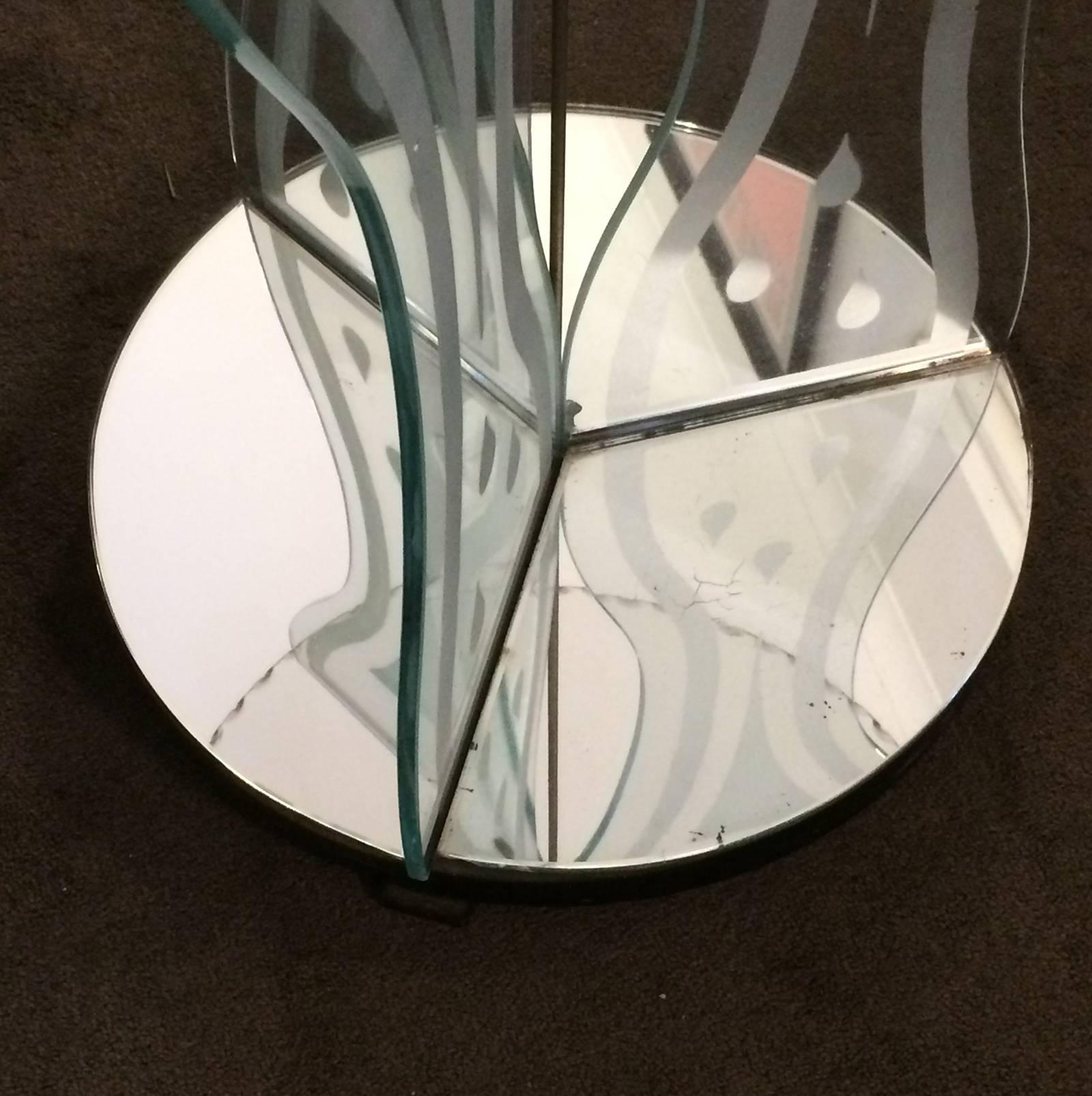 Art Deco round table, with a full perimeter scalloped glass top and chrome disk to centre. There are three etched glass supports and mirrored base in three pieces, to wooden bottom on three small feet. Fantastic original condition. There are a