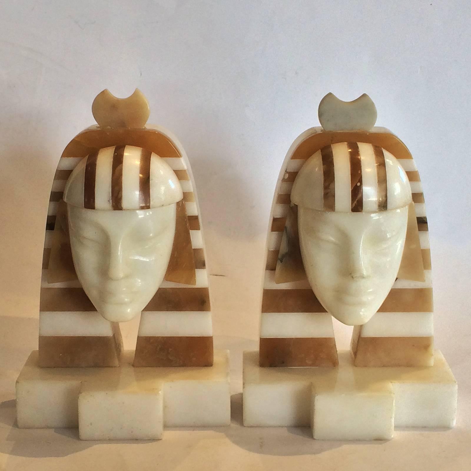 Art Deco Egyptian Revival Bookends in form of a pair of Tutankhamen Faces in Marble and Alabaster. An outstanding example of fine design, with intricate fabrication of “layered” Alabaster to create the Headdress and tapering sides, narrow stripes at