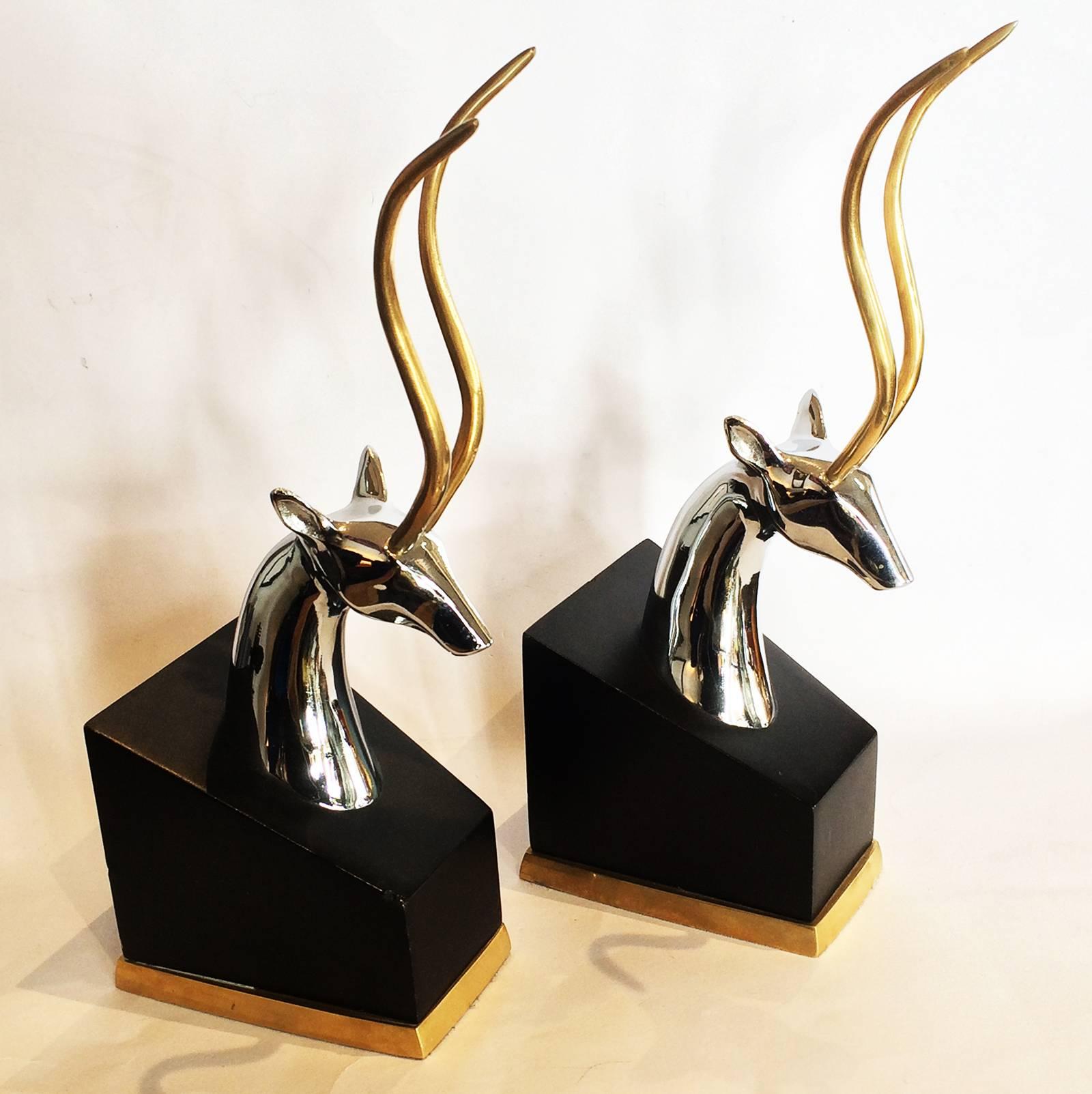 Mid-Century Antelope book ends, in chrome with horns and foot of bases highlighted in gilt, on satin black supports. Absolutely striking design, in excellent condition, with negligible wear for age in form of a couple of tiny edge bumps only,