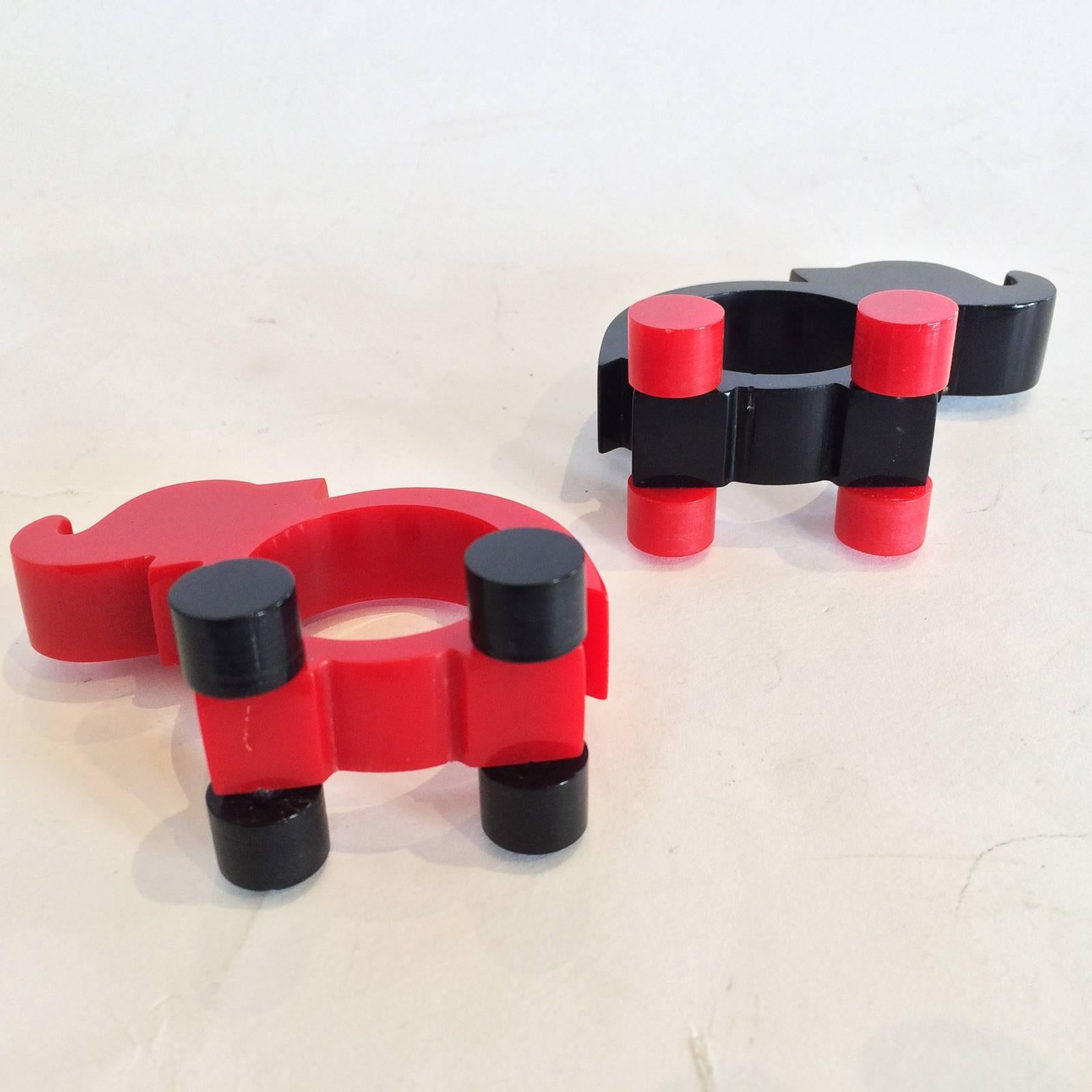 Art Deco pair of elephants in red and black bakelite napkin holders, on wheeled feet. Both perfect with no losses, damage or repairs, circa 1930. U.S.A. Dimensions are approx. : 7.5cm wide x 4cm wide incl. wheels x 5.5cm high.