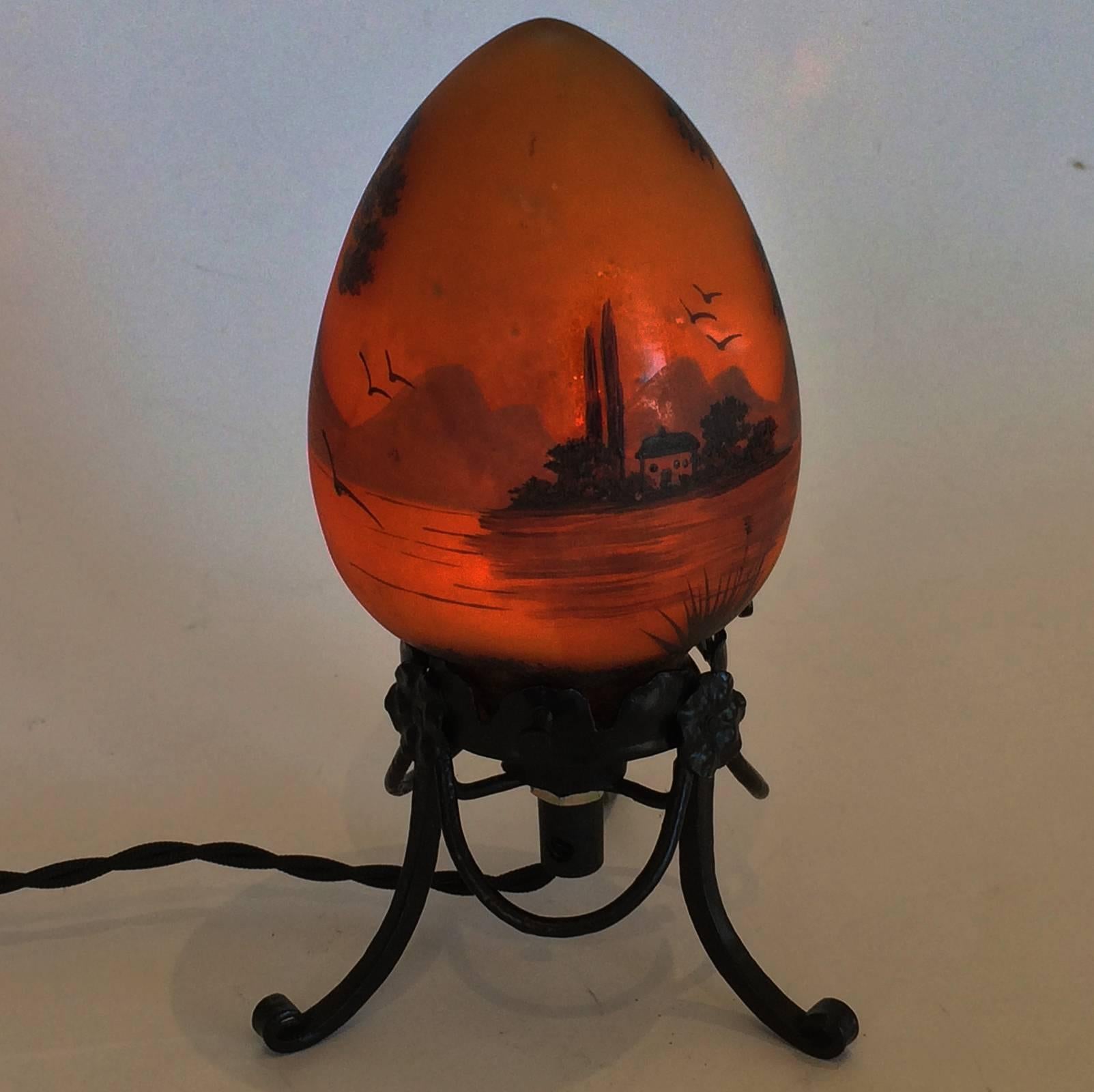 Art Deco French Veilleuse (night light), signed by Jany Peynaud. Truly a magnificent piece of Art in miniature depicting a house beside a lake with trees and birds in flight. Intricate and quality hand-forged iron base, with perfectly shaped, ovoid