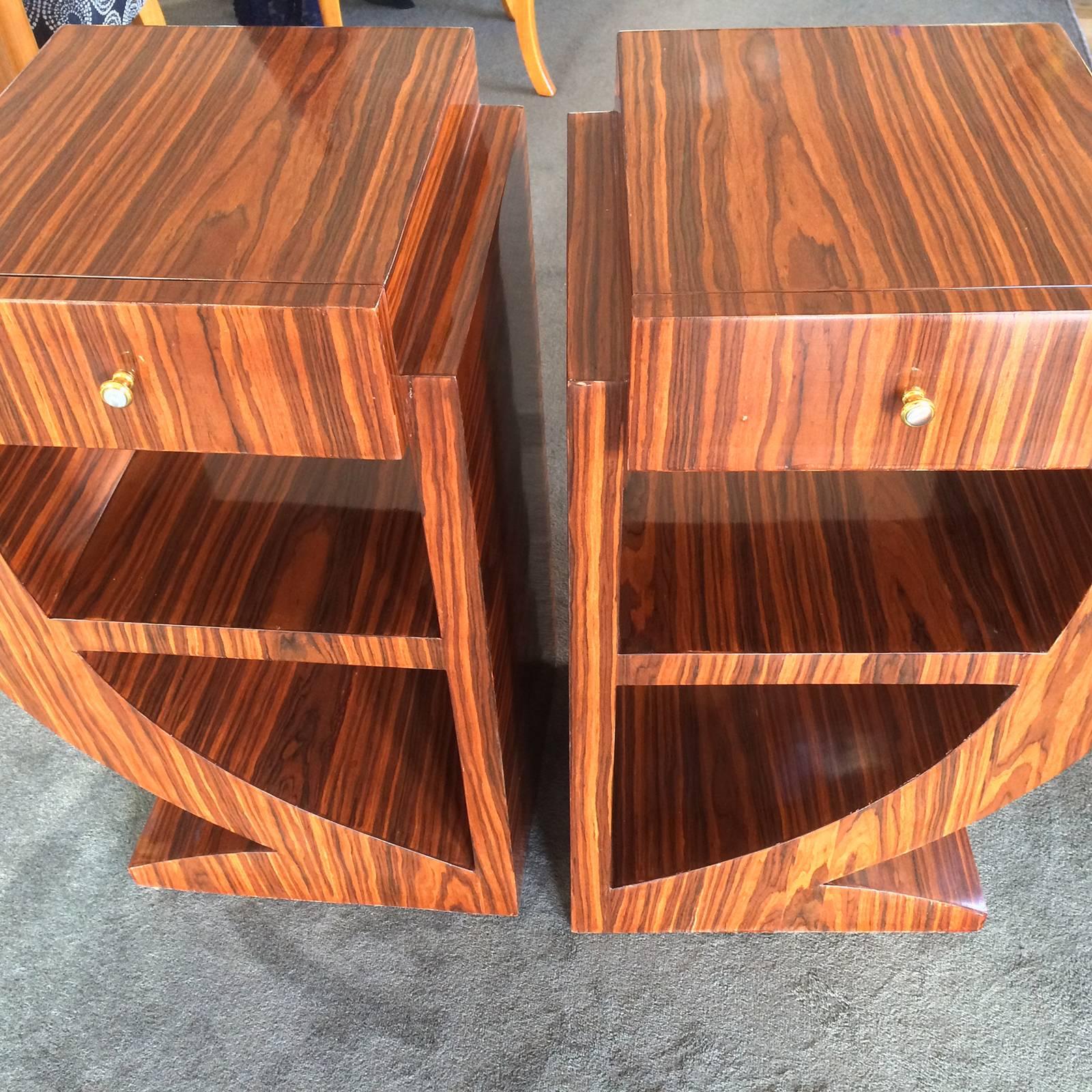 Art Deco style pair of ultra geometric, bedside or sofa tables in Makassar. Each have an upper, full depth draw, with a bookshelf or display area below. The amazing, quality and stepped and curved design, would have to be one of the best examples we