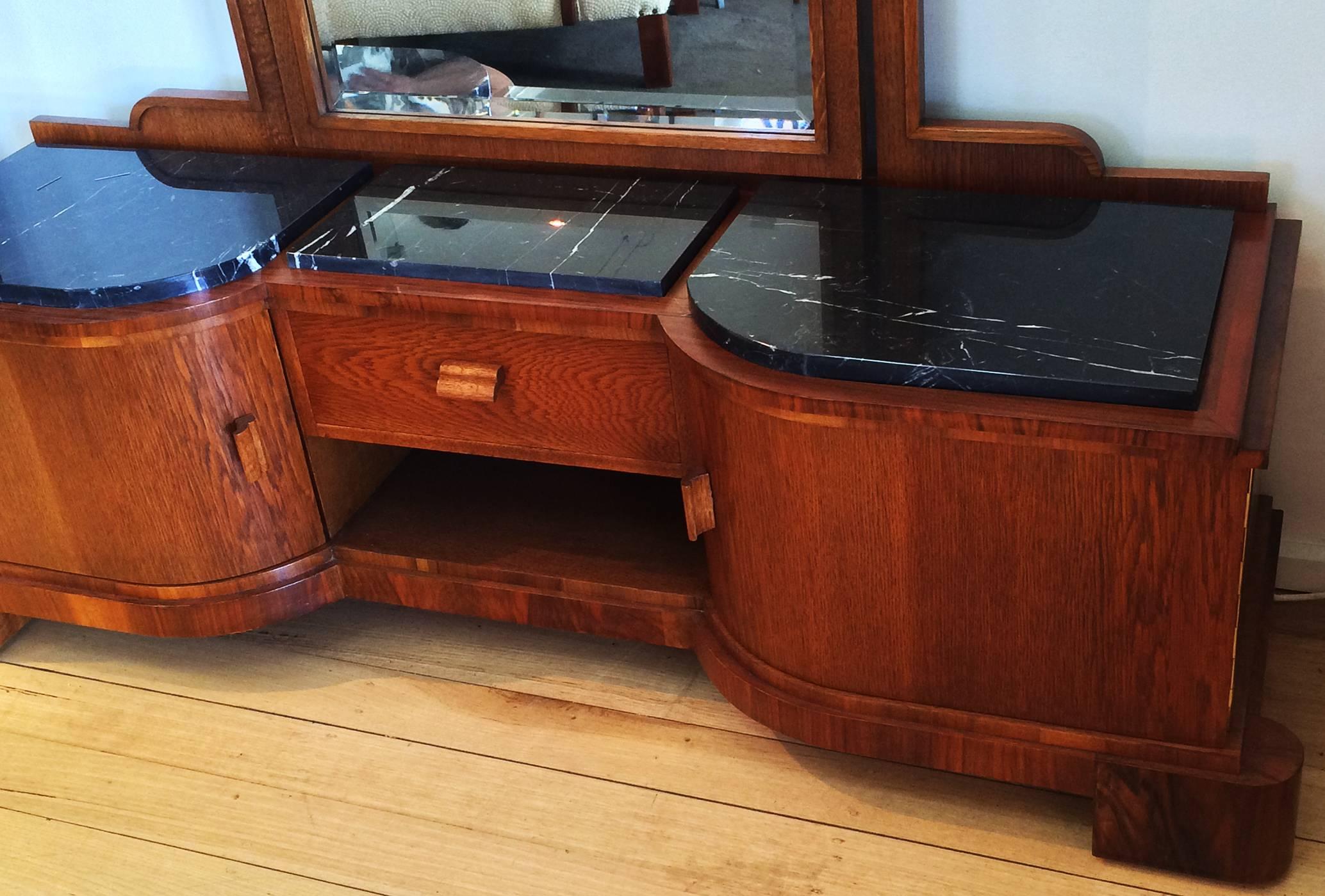 Art Deco German dressing table, with black marble tops and elegant tall mirror. Curved doors strongly supported, each with brass piano hinges. The mirror is intricately detailed with hand bevelled edges. Excellent black with white vein marble to