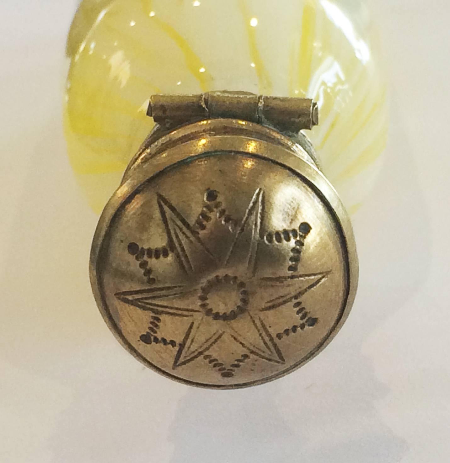 Art Nouveau Perfume Bottle, in striated Yellow and White Glass, with gilt top, original glass stopper, and a rounded end to the glass base. The flip top has a multi-star pattern impressed, and the original hinge is in excellent condition, so too is