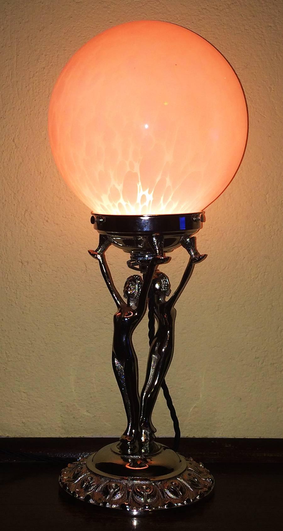An Art Deco English double nude lamp in an early Diana style, circa 1930. This lamp is in near mint condition with its original pink cloud shade.