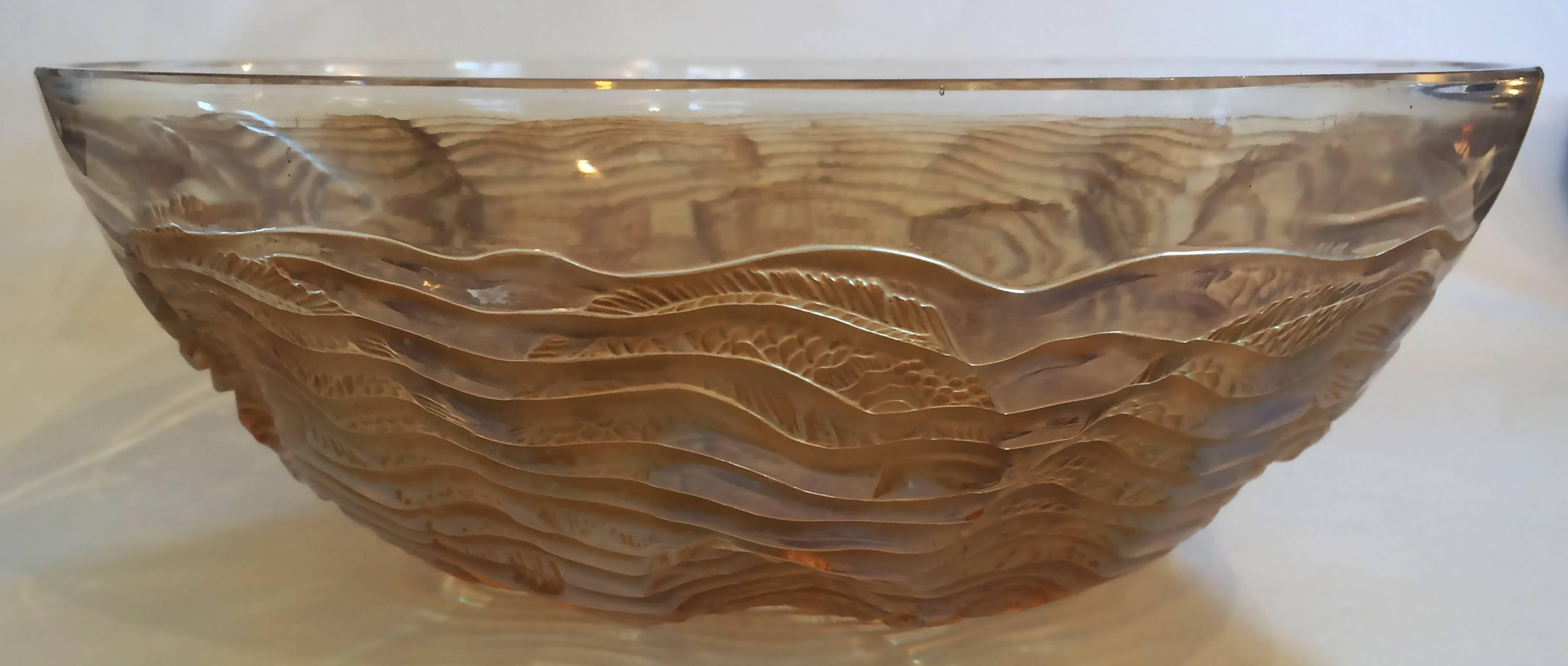 Art Deco bowl, goldfish with gold wash to fish and spiral seaweed. Deep carved design with fine detail to the fish, including scales and the seaweed in the form of a wave spiral starting at centre base, widening out to below the upper rim. Base is