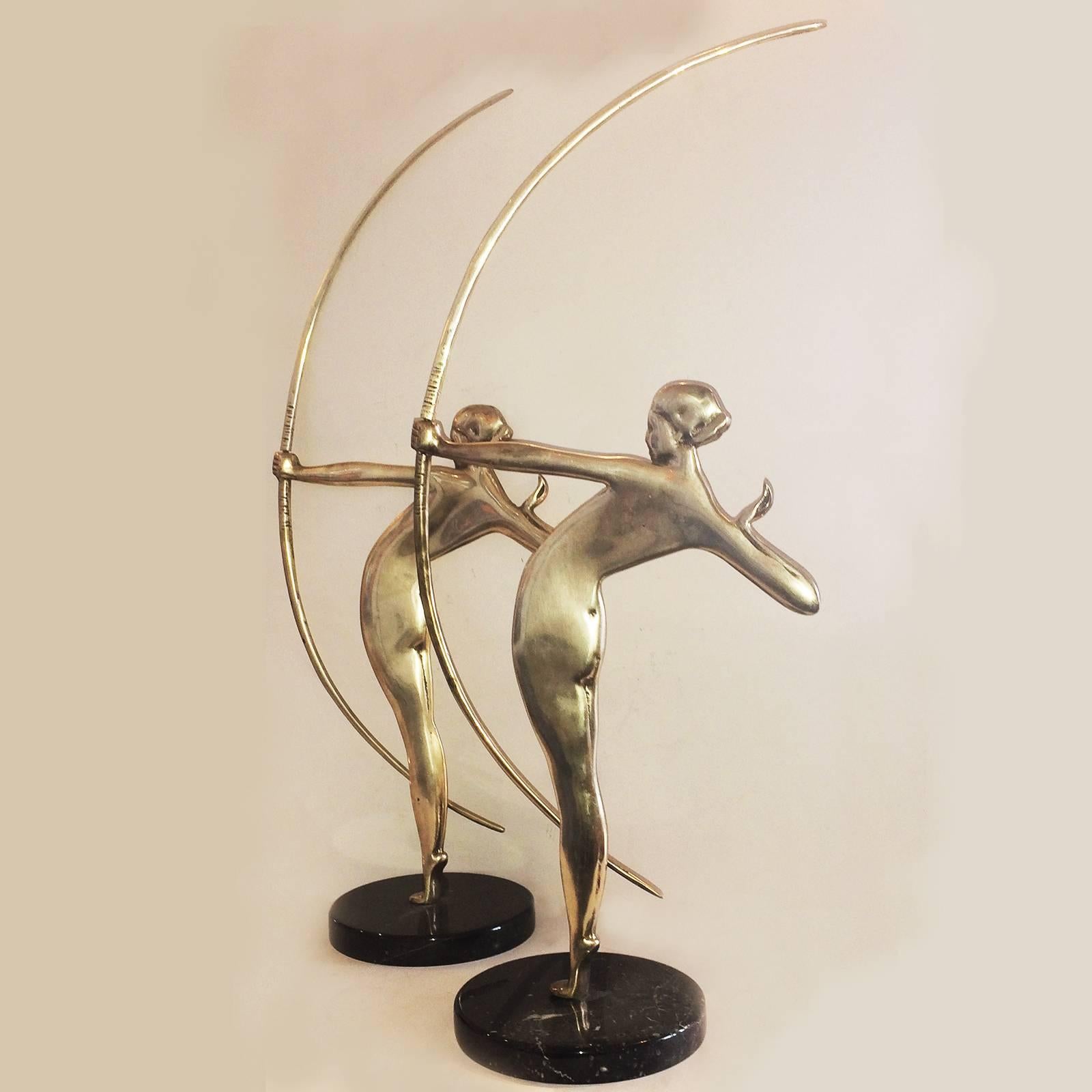 Art Deco, rare pair of large archer figurines, both in excellent original condition, silver-plate on bronze, mounted on white veined, black marble bases, with a soft, aged patina. Dimensions are approximate marble bases are 14.5 cm dia. x 2.2 cm