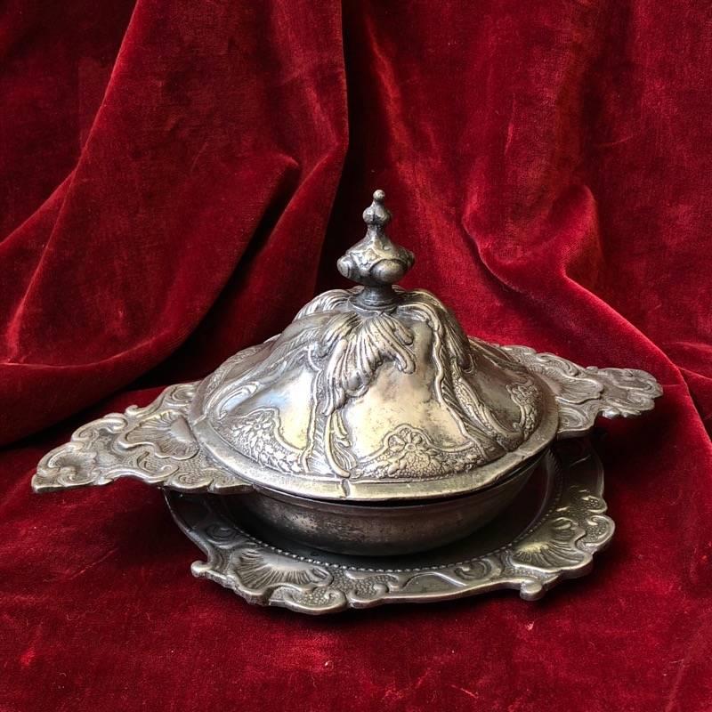Polish pewter rococo form covered bowl and stand, the rim handle and lid moulded with elaborate organic rocaille work, the large knop modelled as a Baroque finial. 
Marked to both bowl and stand with crown and rose mark enclosing initials 'IN'