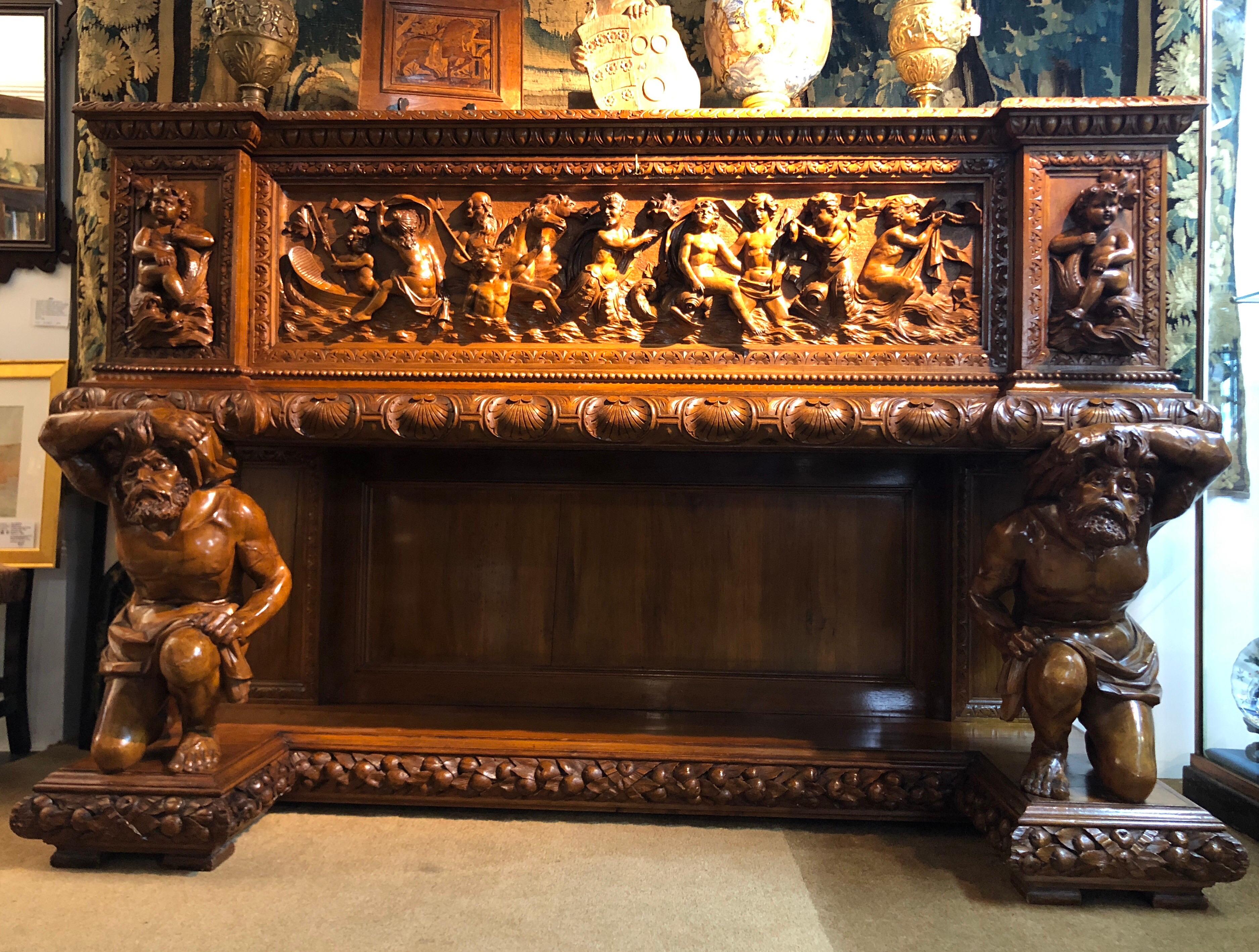 Large North Italian walnut Cassone, in the Baroque Revival style with superb figure carved panel to the large door depicting Neptune and his band of nymphs, flanked by two deep drawers decorated with a cherub astride a dolphin, the whole supported