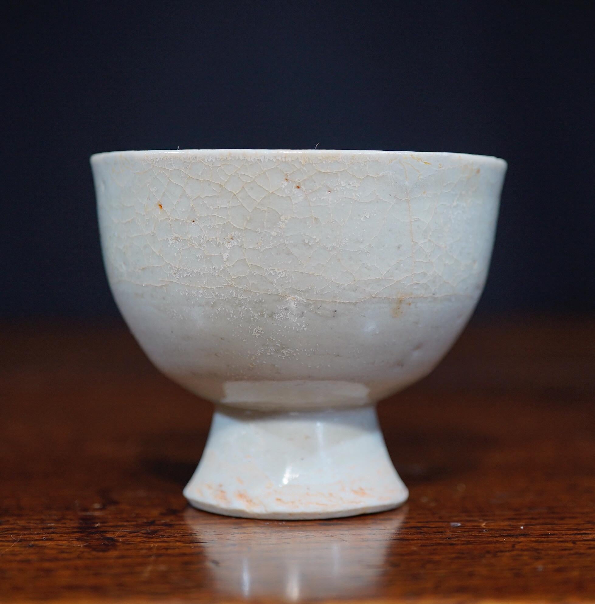 Chinese celadon glaze stem cup of small size, the deep cup on a short spreading base.
Yuan Dynasty (1279-1368).

Provenance: Australian collection, purchased New York, circa 1980.