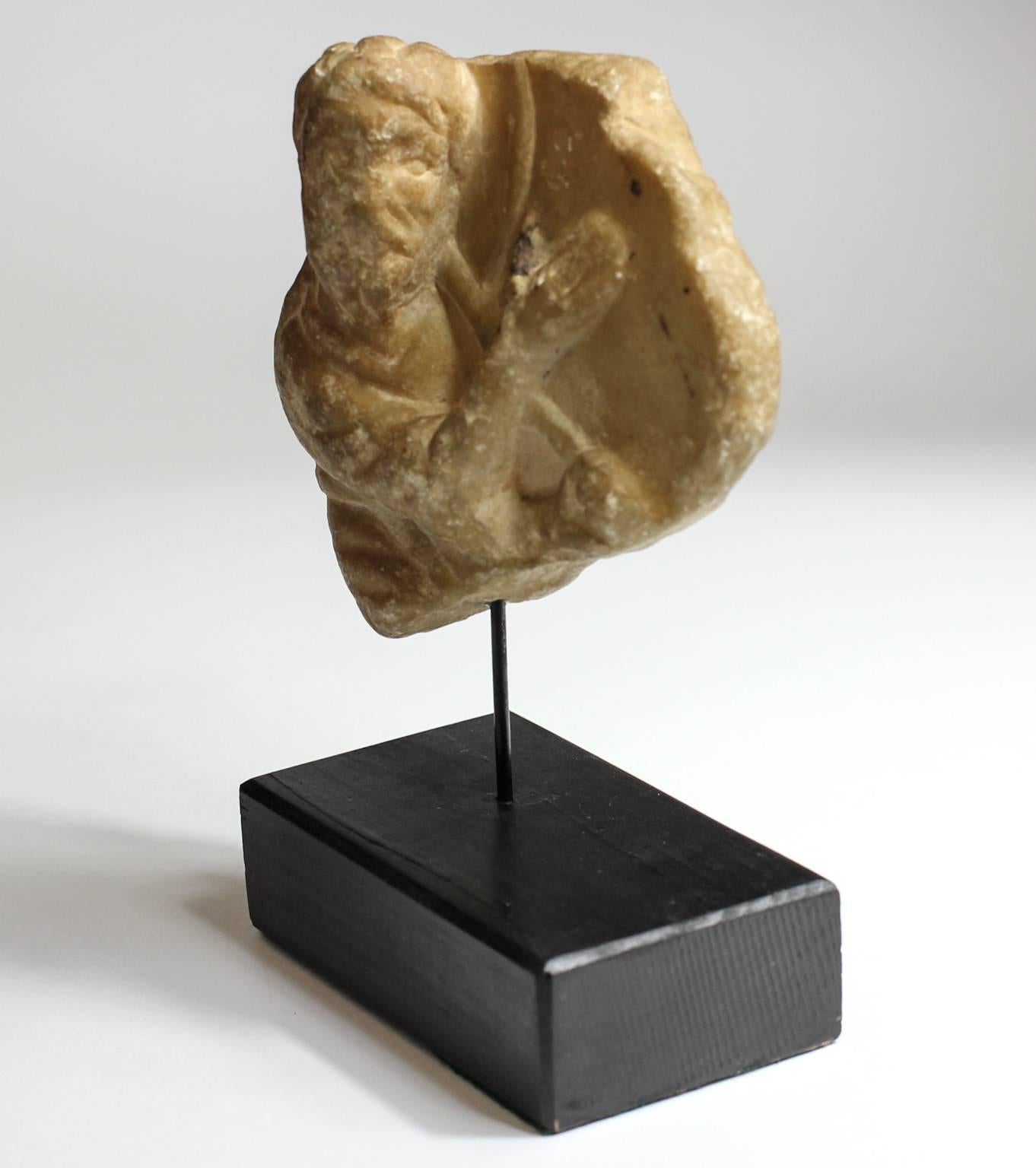 Early Christian marble font fragment, showing a figure with raised hand and holding a staff, perhaps St John. 
Probably from Turkey, 
circa 12th-14th century AD.