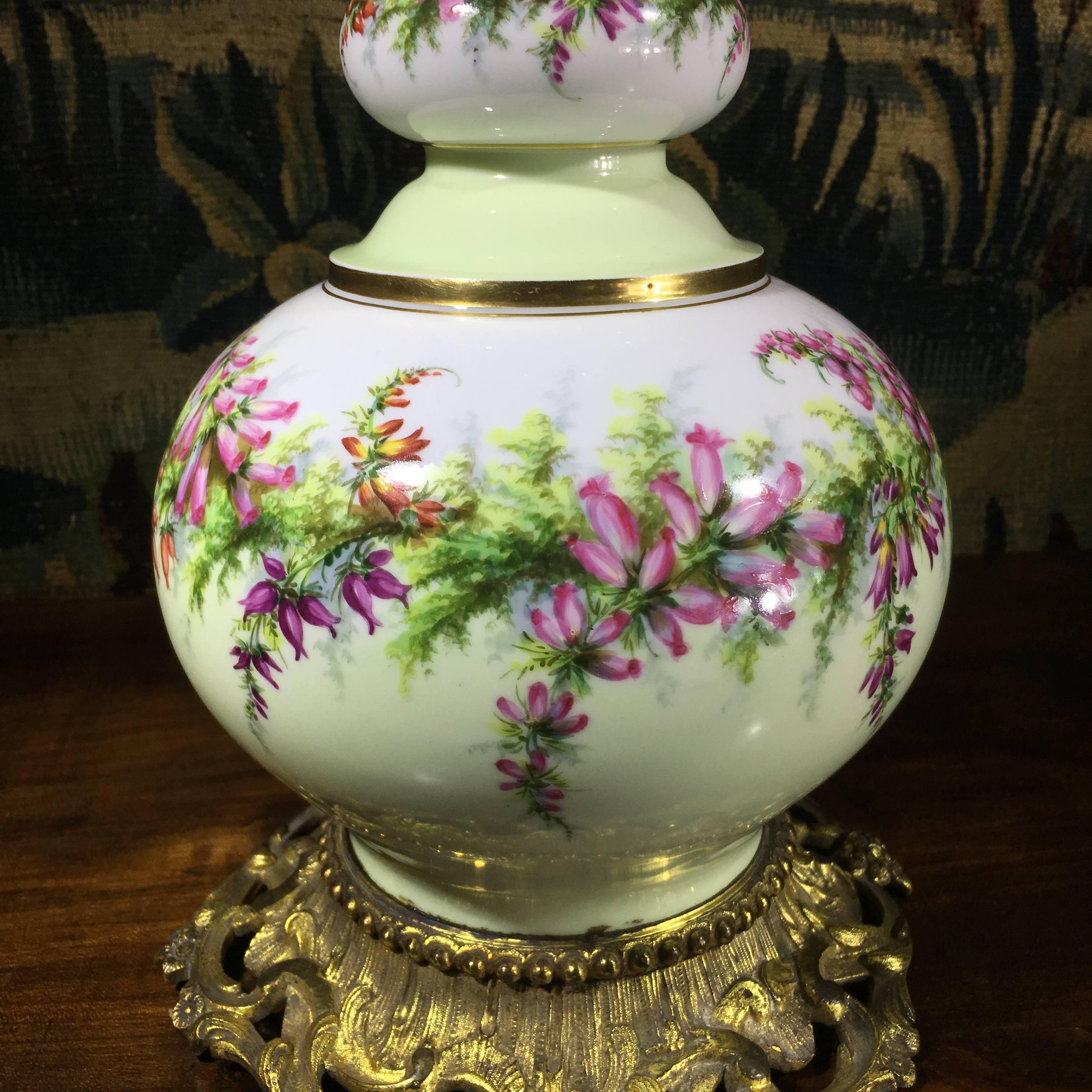 Handsome large Victorian porcelain vase, superbly painted with wreaths of flowers including heather, with early electric light conversion, possibly from an oil burner. 
circa 1885.