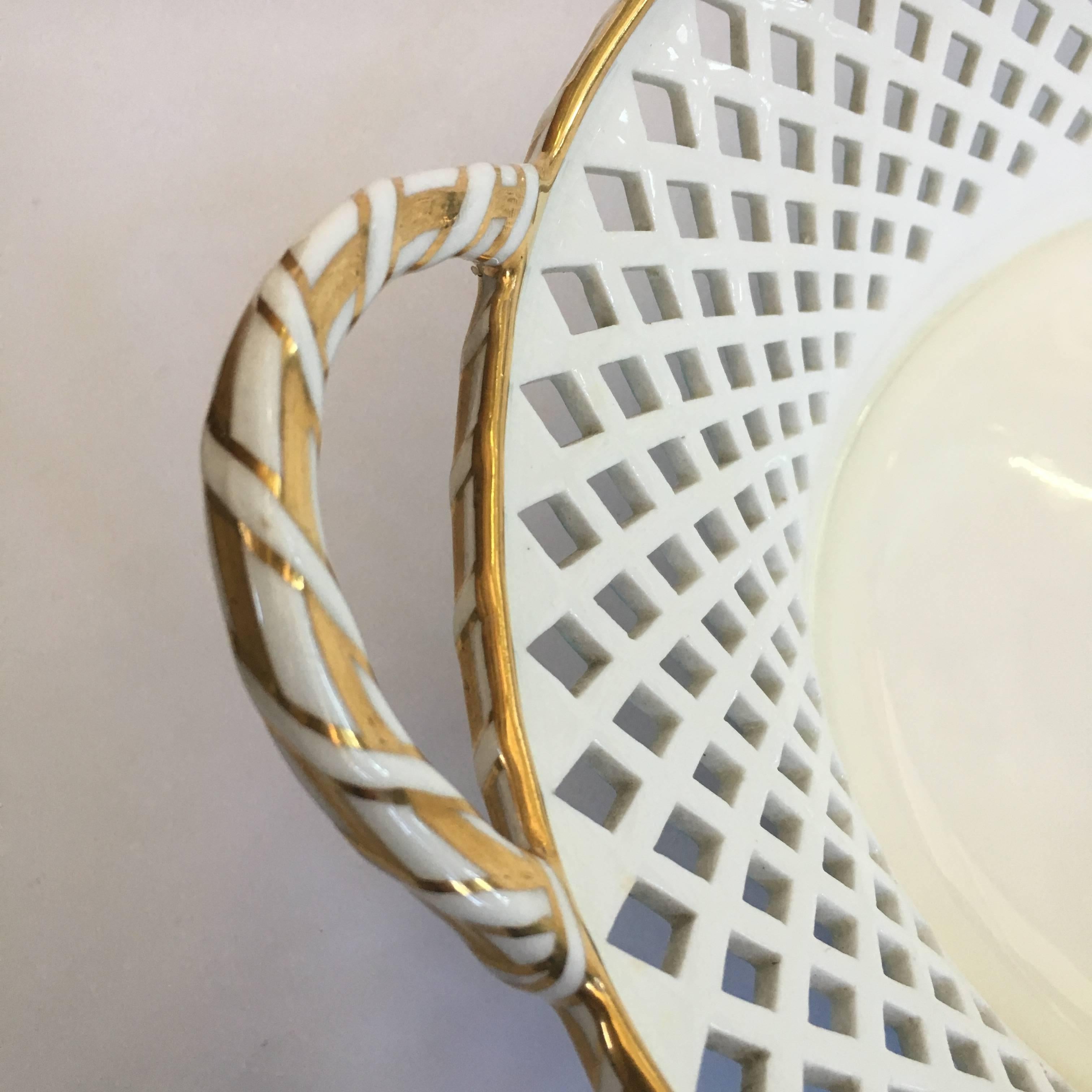 Minton pierced porcelain basket, decorated in turquoise, the rim with gilt 'ribbon' bound highlights. Impressed Minton and date code for 1886, printed retailers mark for T. Goode & Co, London.
 