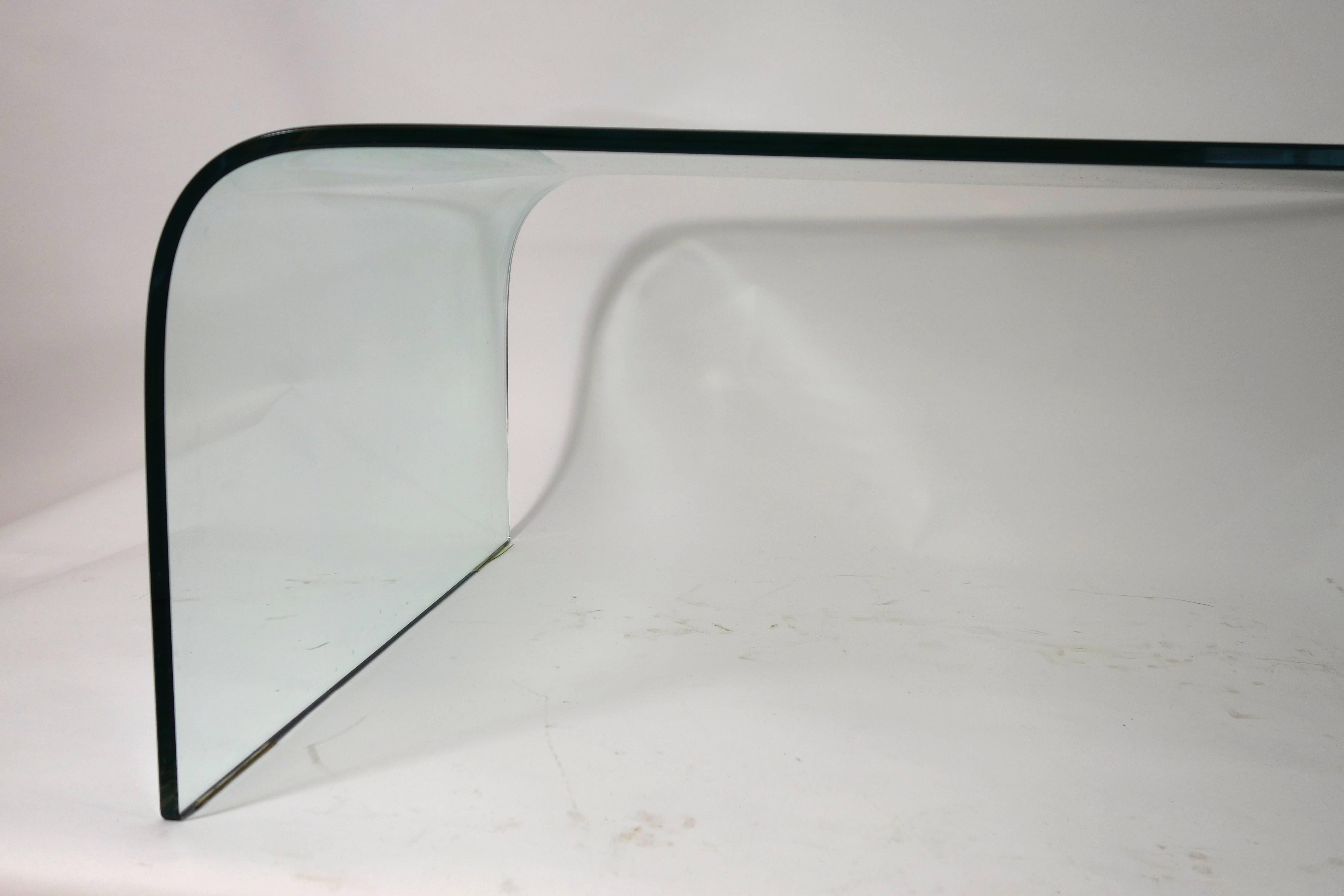Glass cocktail table designed by Angelo Cortesi for Fiam Italia, named Waterfall. Very elegant yet solid and spacious table made of thick curved glass.