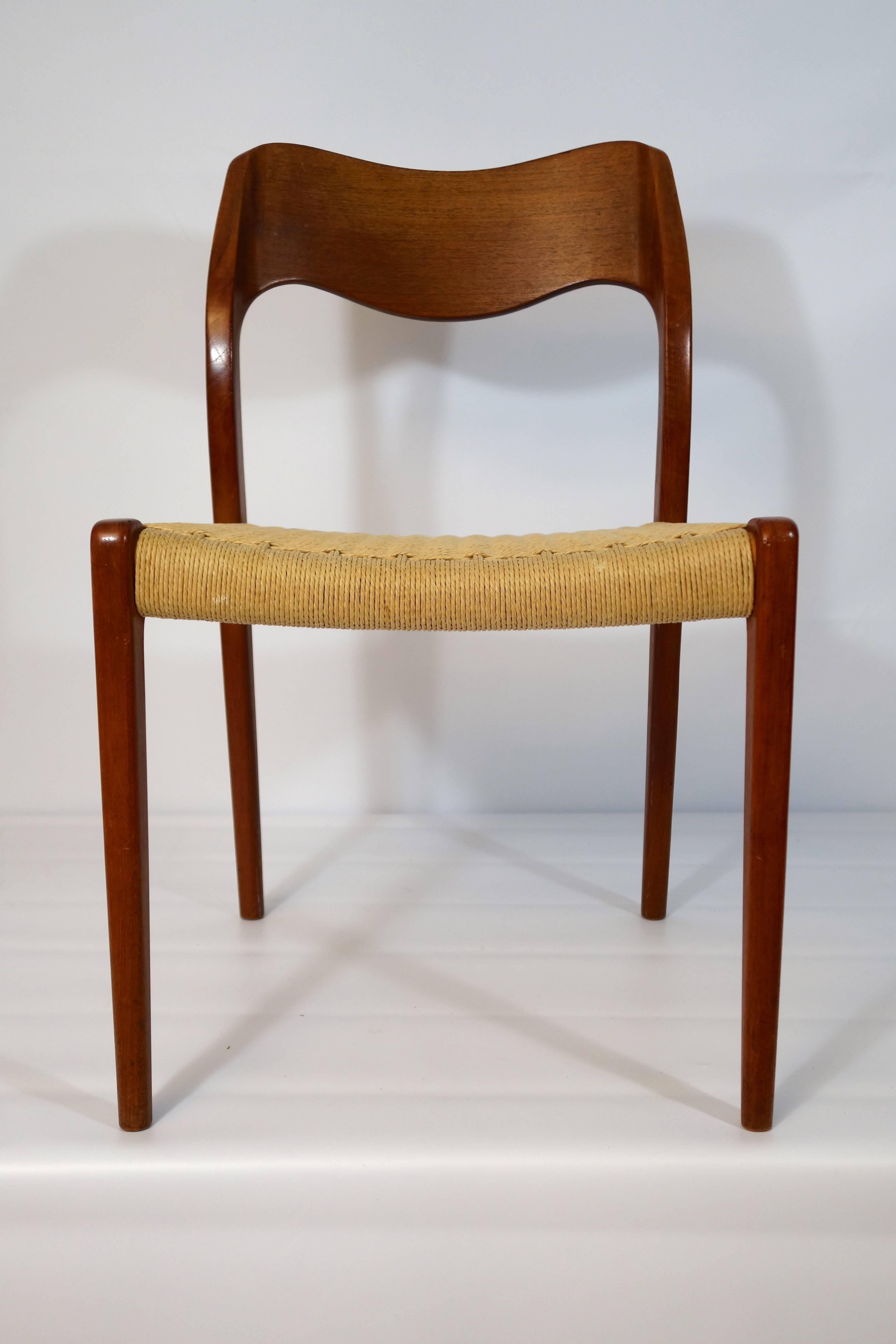 Set of four teak dining chairs '71' designed by Niels O. Moller for J.L. Mobelfabrik, with the original woven paper cord seats.
The curvature of the back rests in two directions (both backwards as on the lower side of them) is what distinguishes the