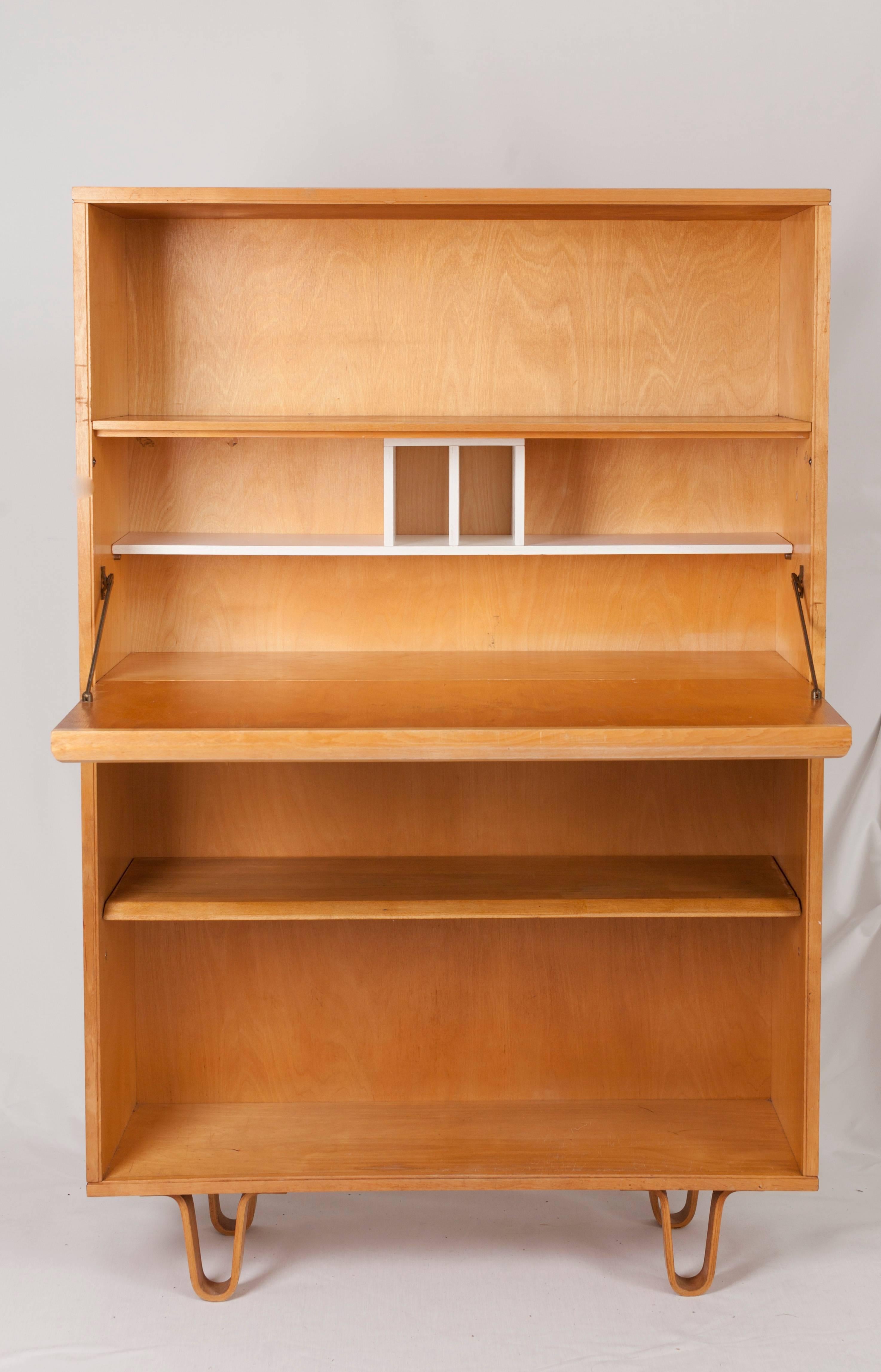Midcentury Bookcases slash Writing Desks BB02 by Cees Braakman for Pastoe.

Just open the flap and you turn the bookcase into a practical writing desk.

The birch wood, their butterfly shaped legs and the white inner lay-out make the bookcases slash